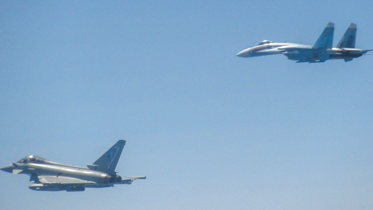 An RAF Typhoon (left) flying alongside a Russian Su-27 Flanker on 22 June (Picture: RAF).