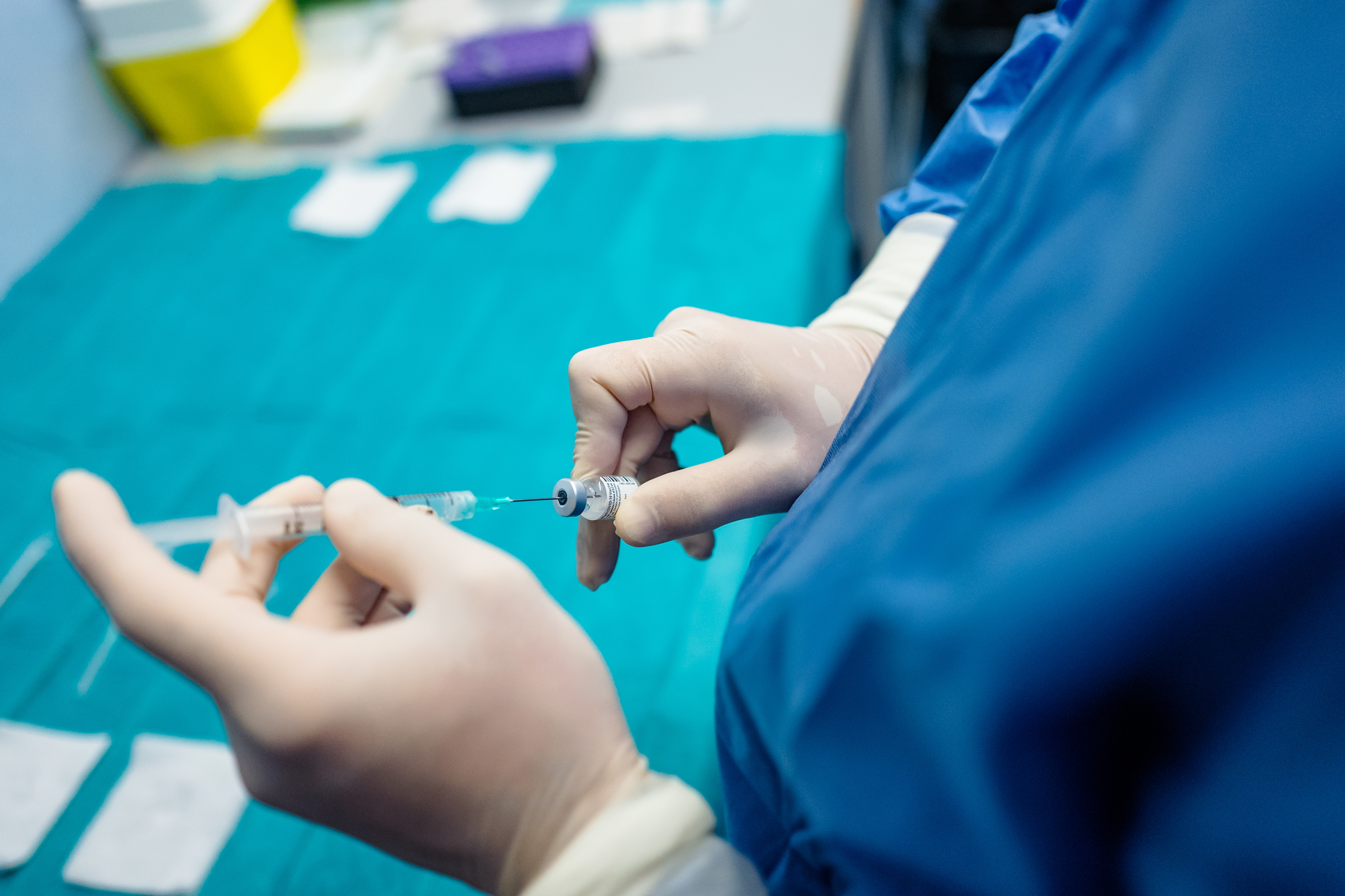 Anonymous medic preparing coronavirus COVID-19 vaccine injection in Italy