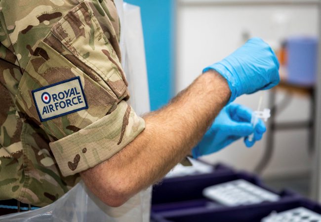 Cover image: RAF service member carries out coronavirus testing duties (Picture: MOD).