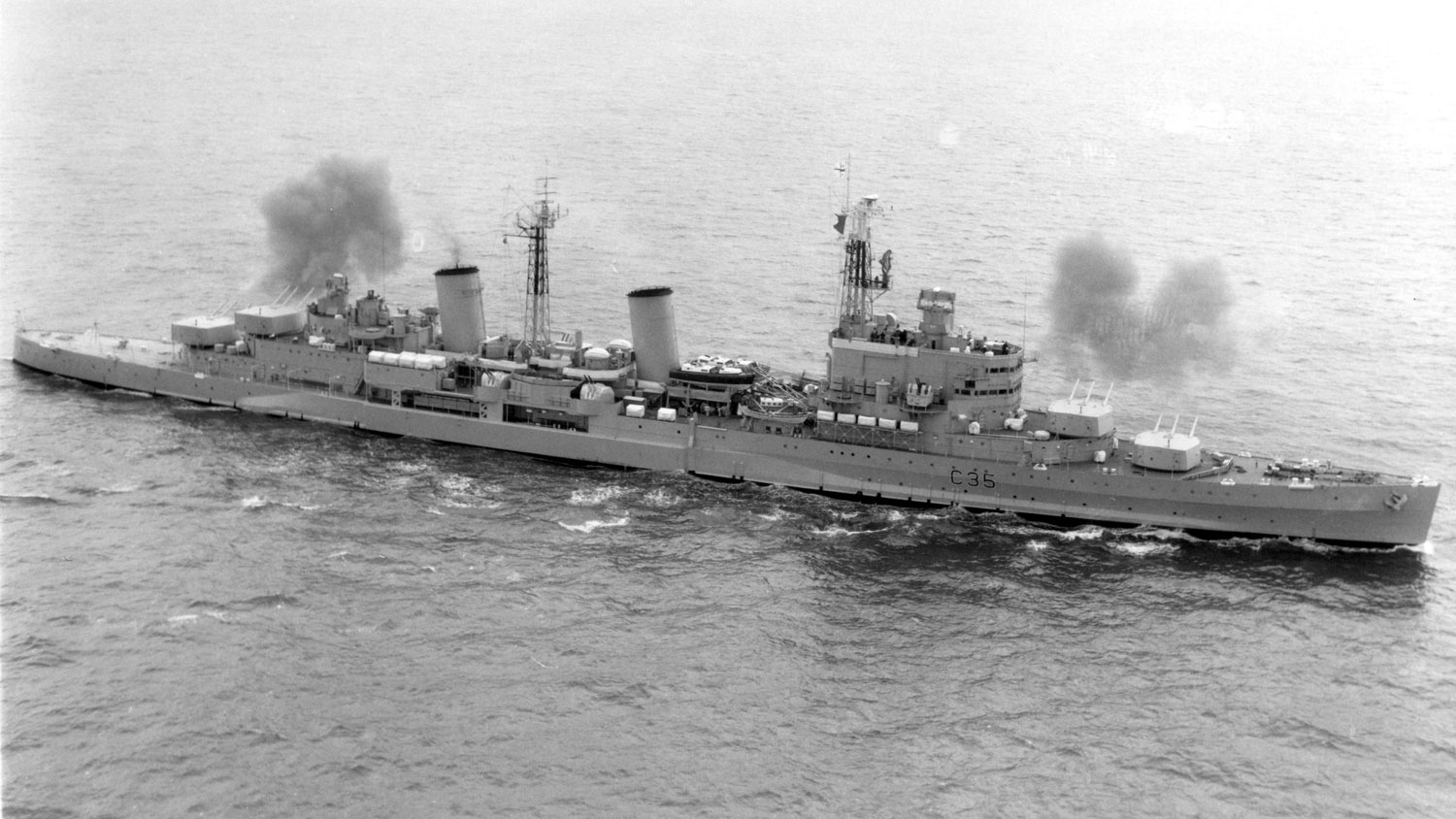Archive image shows HMS Belfast firing a broadside during the Second World War CREDIT Crown Copyright