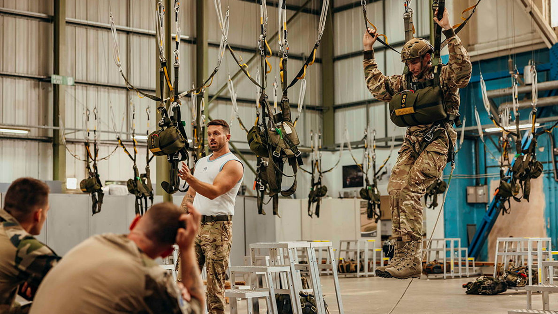 Army Parachute Jump Instructor’s demonstes flight drills in the flight swings to paratroopers from the French 11e Brigade Parachutiste CREDIT MOD
