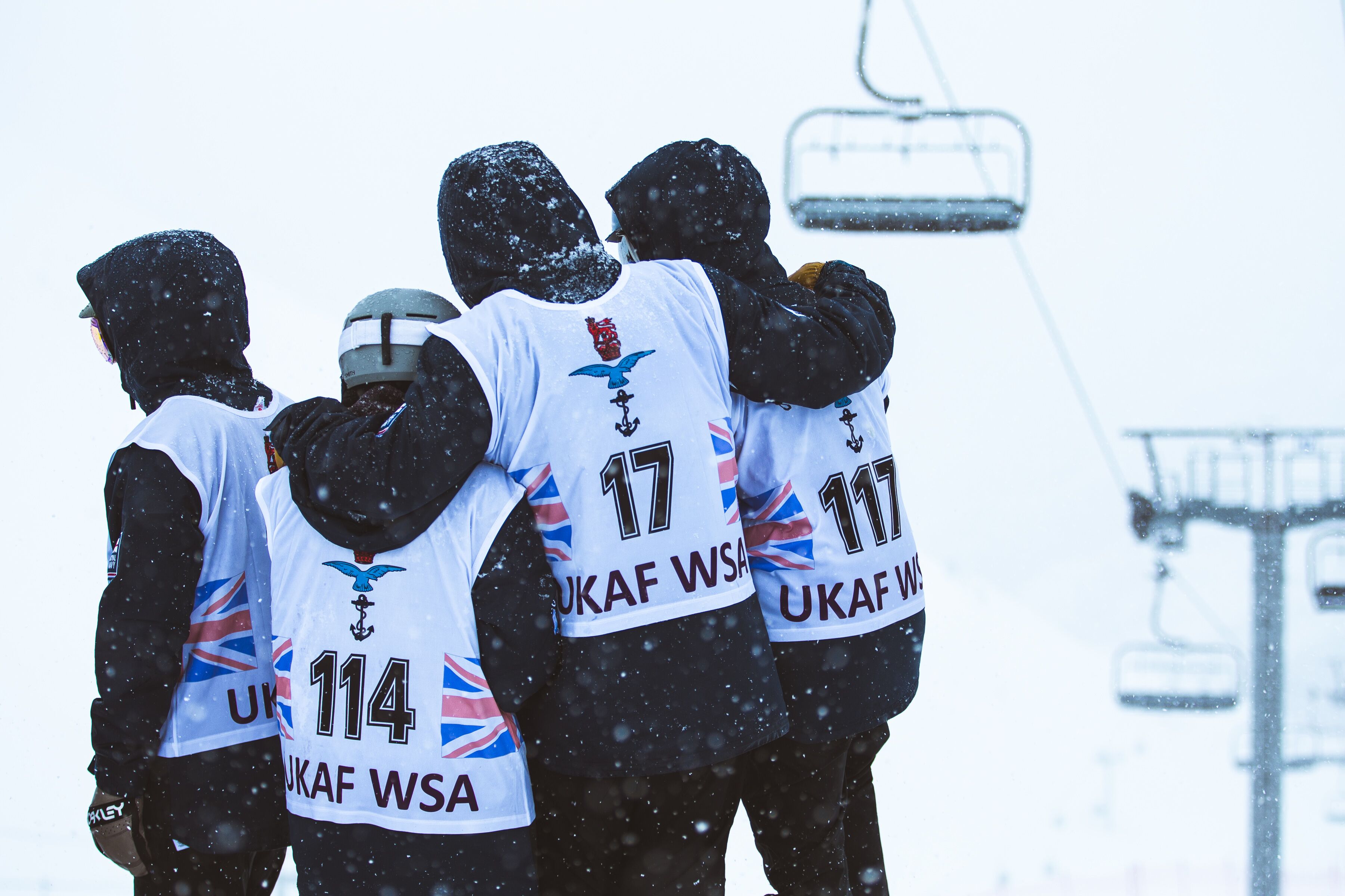 Snowboarders huddle during bad weather on Sunday (Picture: Crown Copyright).