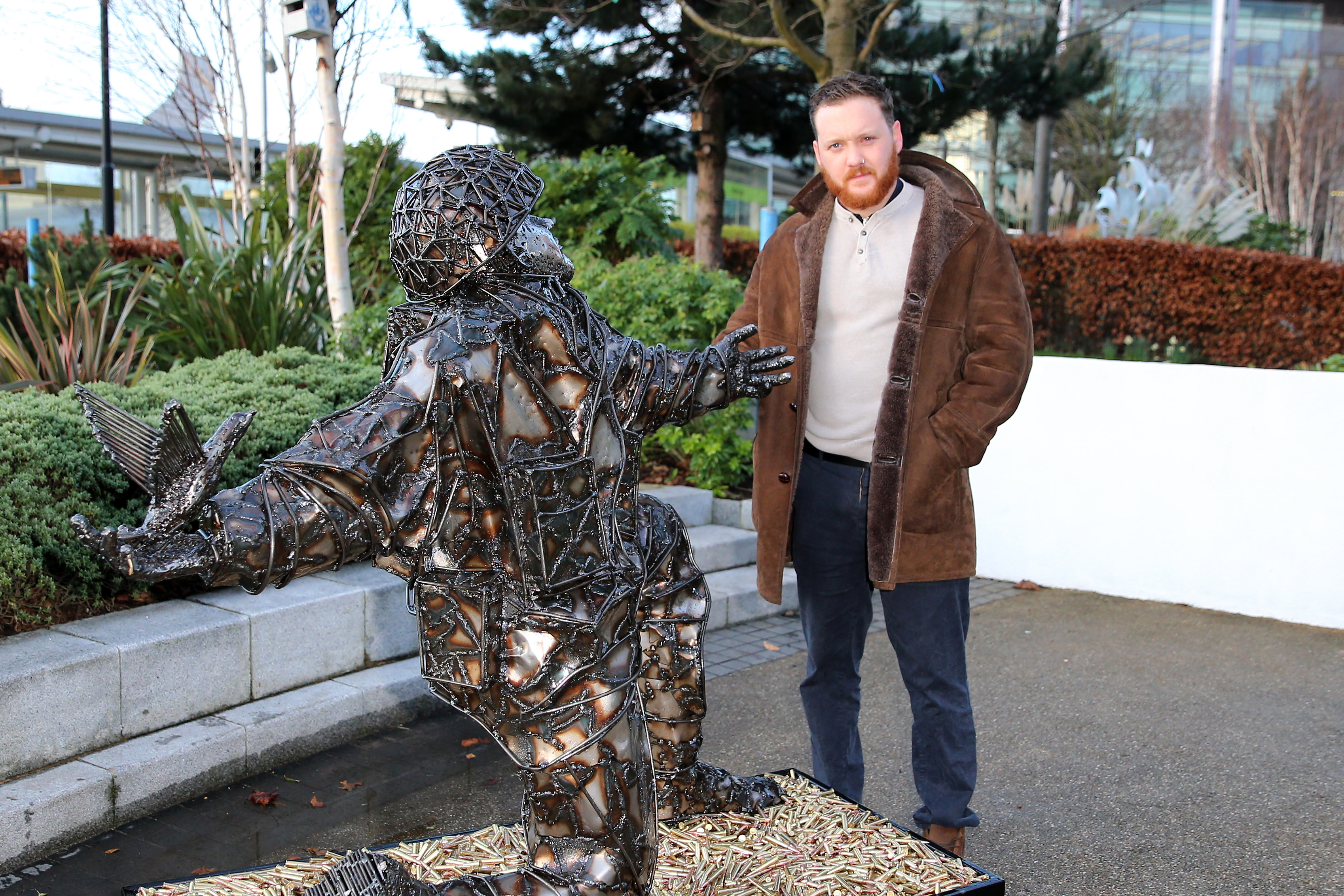 Artist Alfie Bradley with D-Day Soldiers of Sacrifice statue (Picture: The D-Day Story museum).