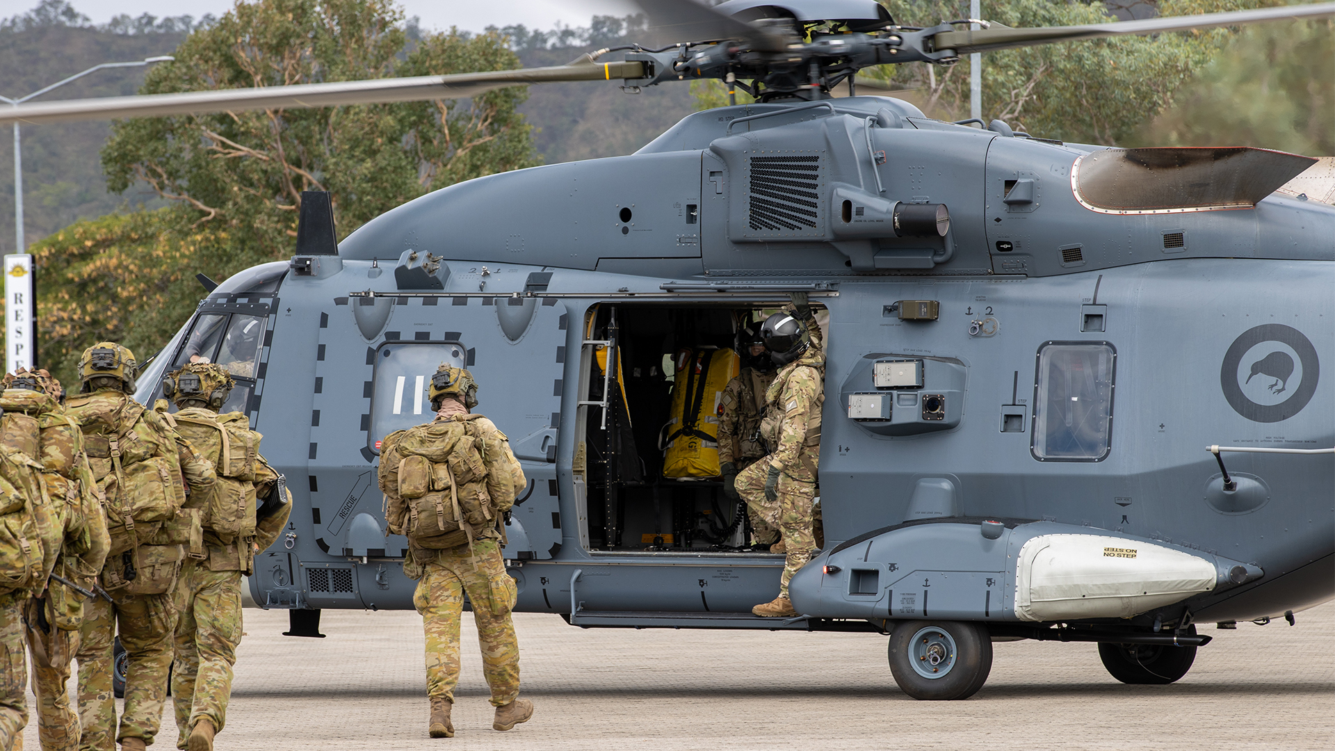 Australian Army soldiers prepare to board a Royal New Zealand Air Force NH90 helicopter in a display on international cooperation