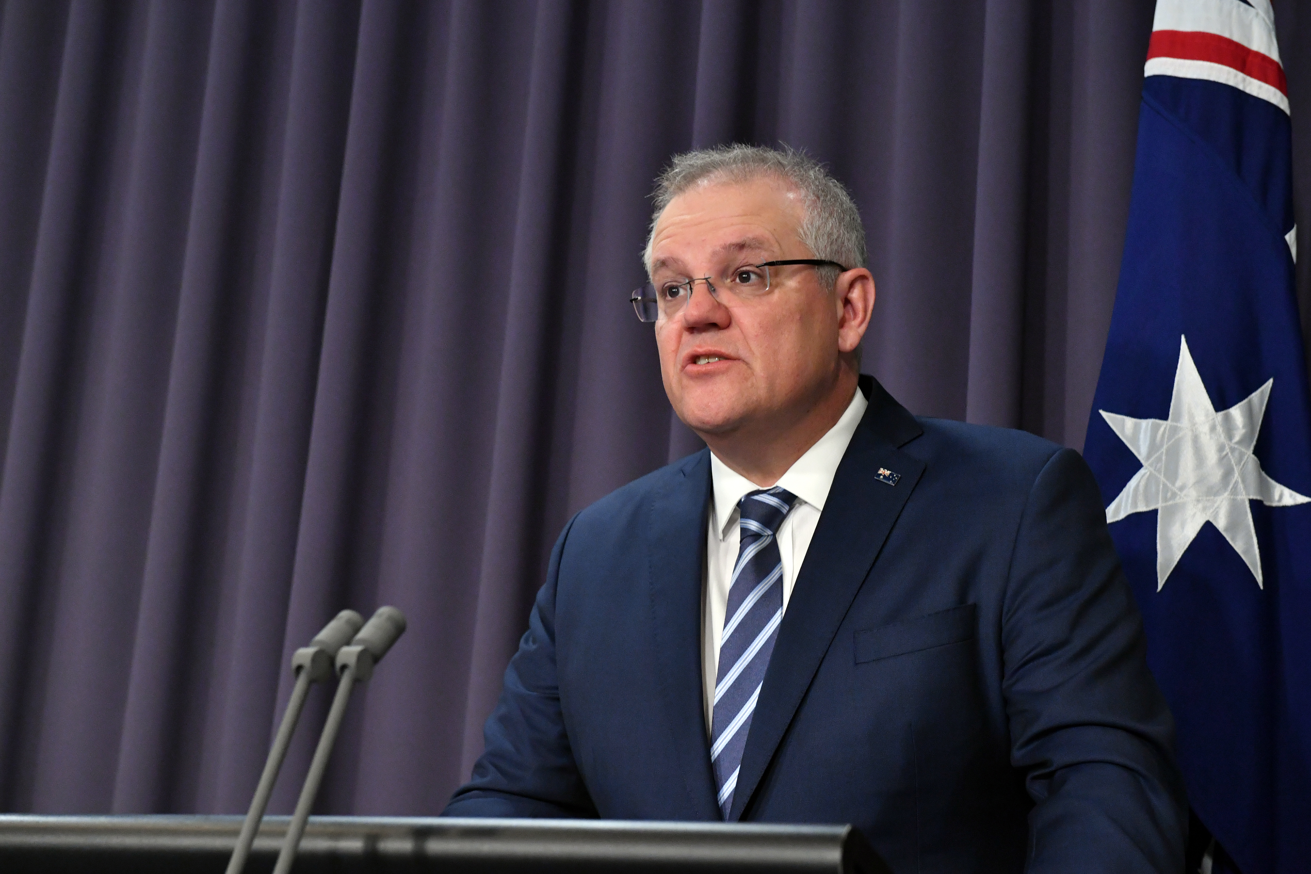 Cover image: Scott Morrison speaking at a press conference (Picture: PA).