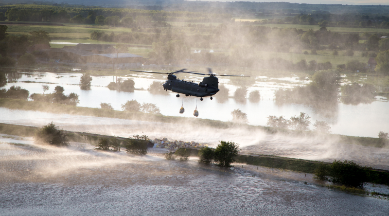 a RAF Chinook, seen here dropping ballast's of sand in a bid to block a breach in the River Steeping, Wainfleet, Lincolnshire.