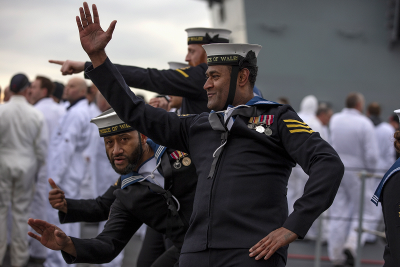 Sailors from HMS Prince of Wales, wave to the crowds as she comes into Portsmouth Harbour.