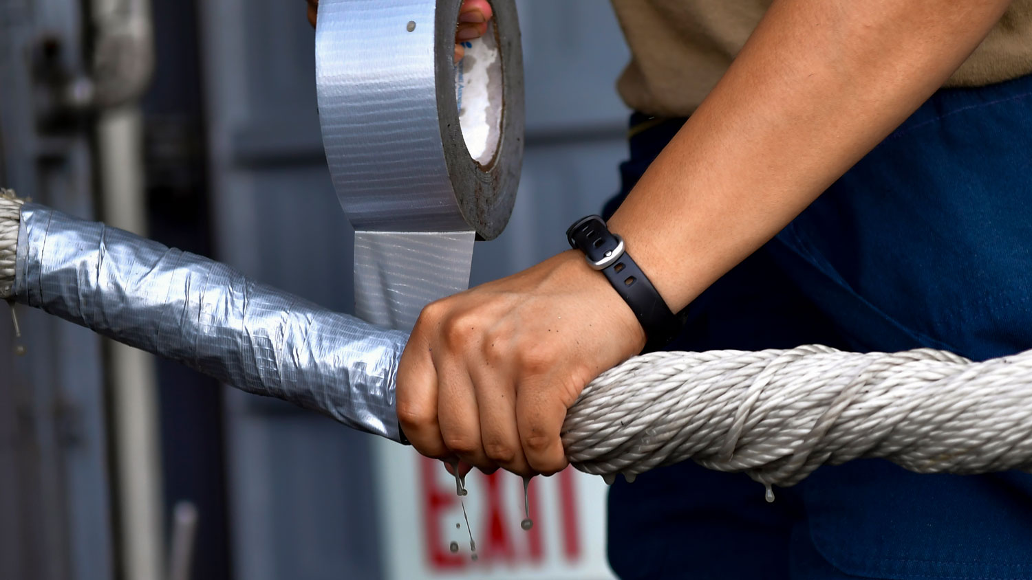 Boatswain's Mate Seaman Vanessa Losano wraps duct tape around a strand of mooring line on the fantail of the aircraft carrier USS Nimitz on 14 October 2020 (Picture: US Navy).
