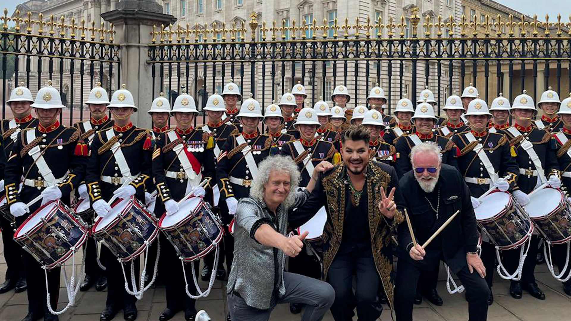 Bands of HM Royal Marines pose with singers Adam Lambert and Dr Brian May outside Buckingham Palace 040622 CREDIT RMBandService Twitter