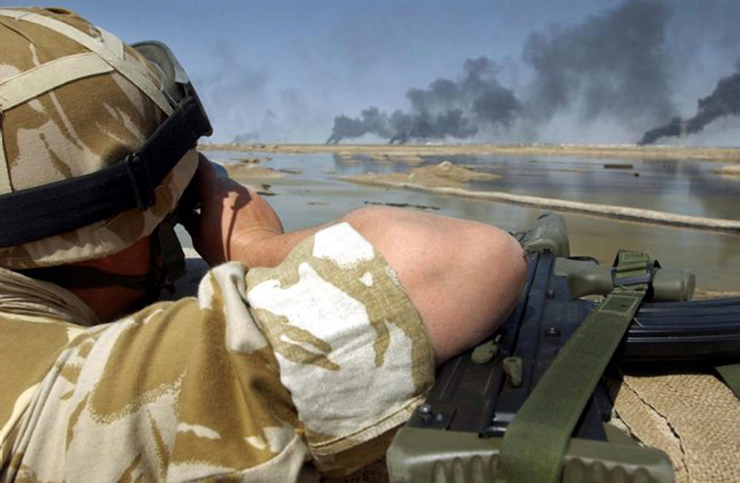 A British soldier observes the city of Basra from the far bank of the Shatal Basra Waterway. A British soldier observes the city of Basra from the far bank of the Shatal Basra Waterway.