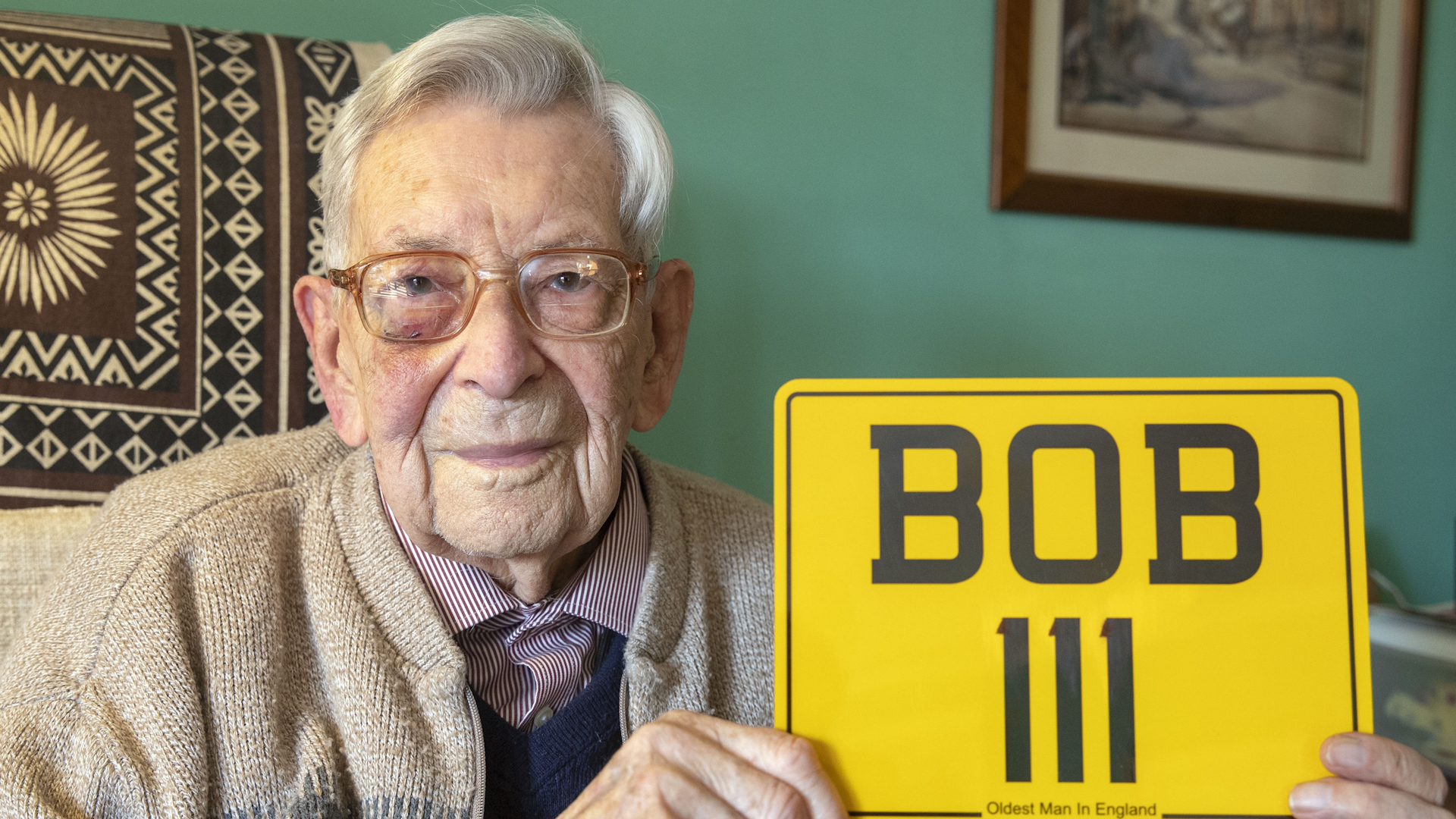 Bob Weighton with his new number plate to mark his birthday (Picture: PA).