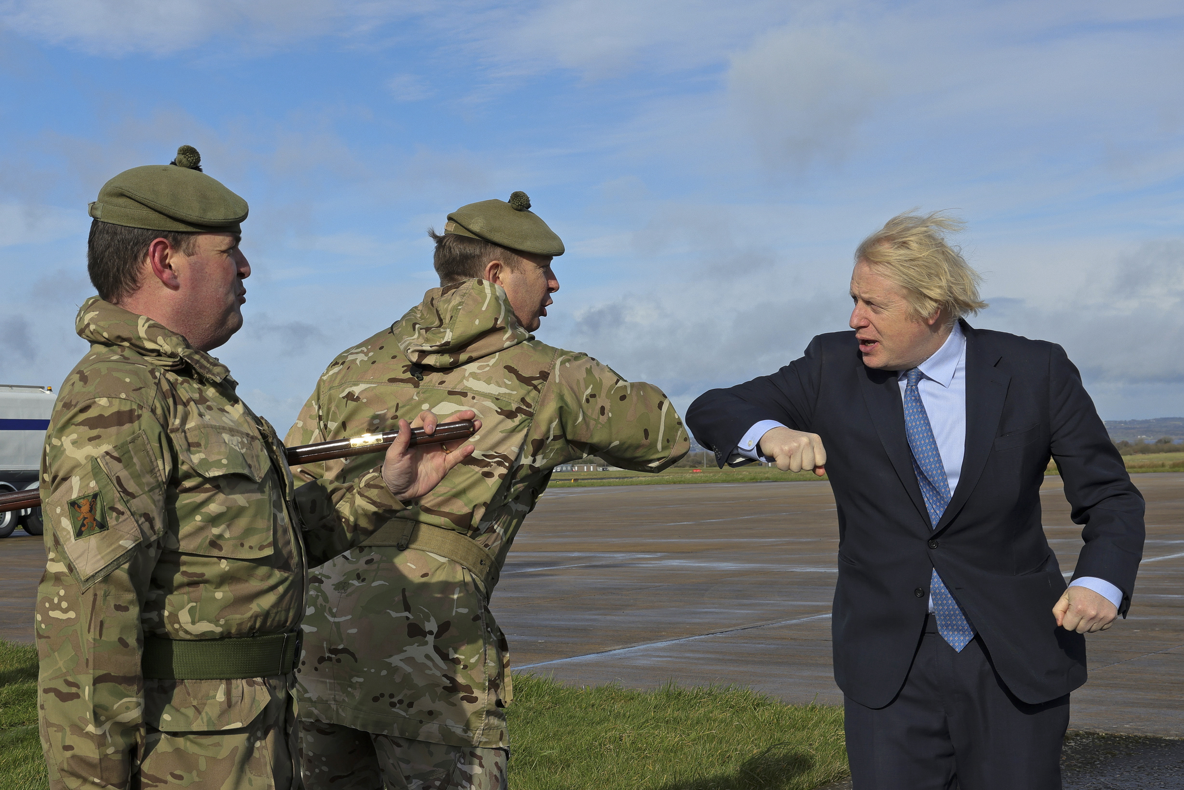 Boris Johnson, pictured meeting personnel assisting with COVID-19 in Northern Ireland last week, announced a £16.5bn defence boost last November (Picture: MOD).