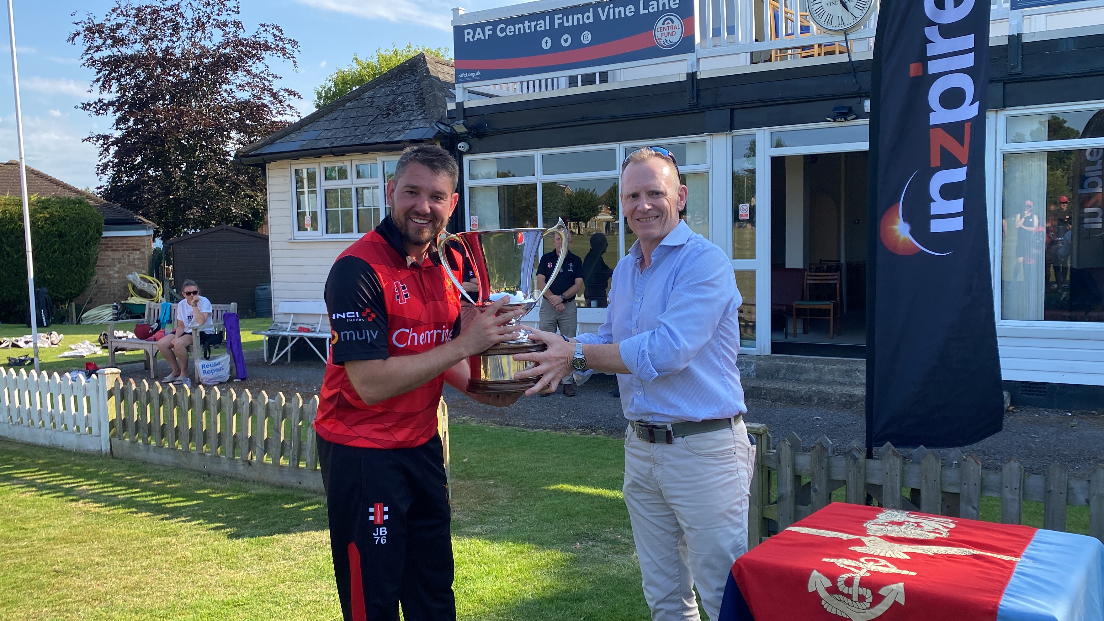 British Army Captain Jay Boynton lifts cricket Centenary Trophy with Major General Jez Bennett