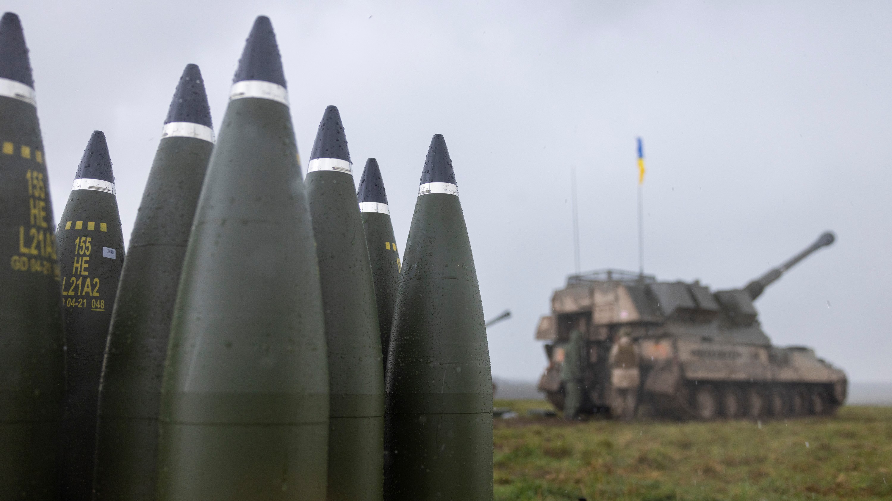 British donated 155mm artillery rounds stacked behind line of AS90s and their Ukrainian operators 24032023 CREDIT MOD Crown Copy