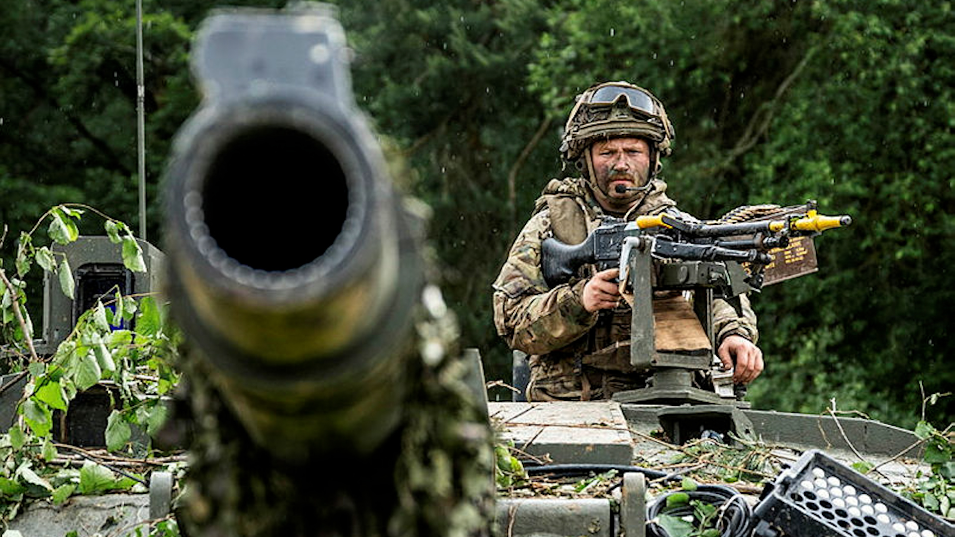 A British soldier mans the 7.62mm GPMG on his Challenger 2 main battle tank during Exercise Combined Resolve 24-02