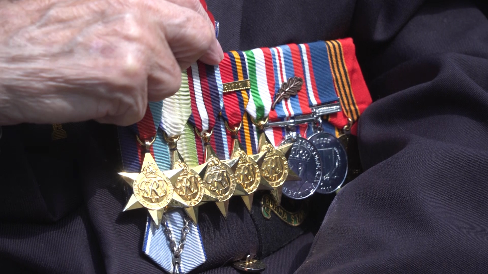 Burma veteran Roy Miller shows Forces News his medals.