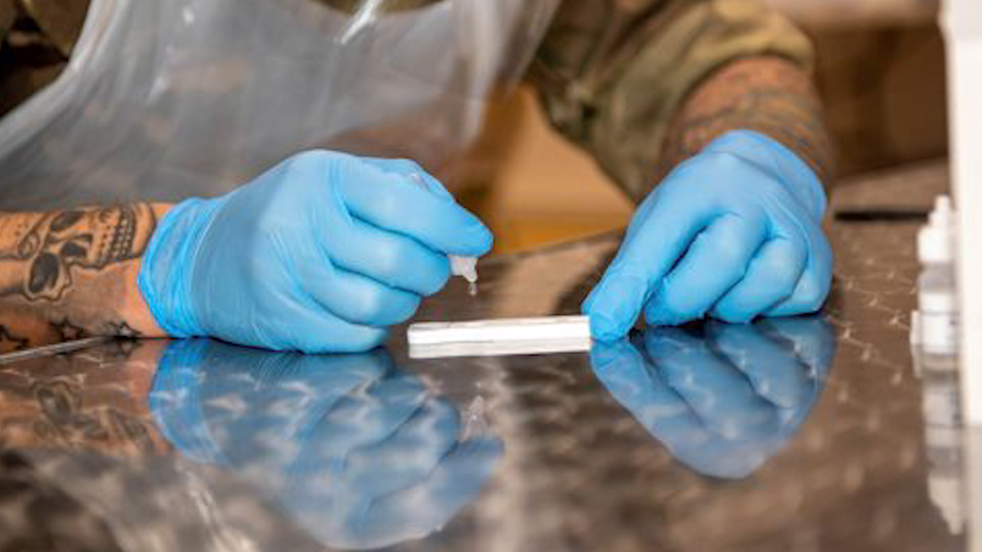 Cover image: Soldier inspects coronavirus testing equipment during Liverpool's mass testing pilot scheme (Picture: MOD).