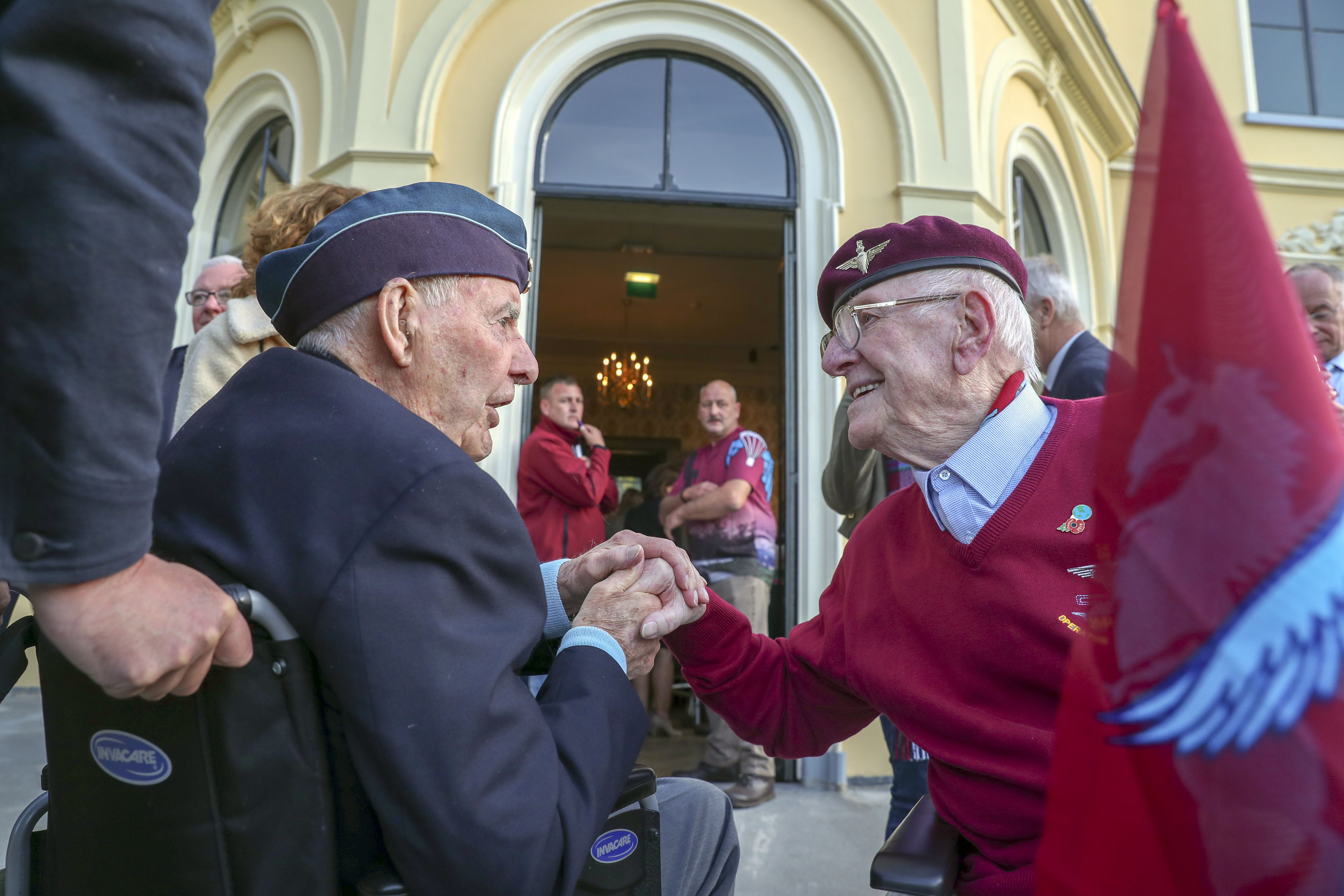 Canadian veteran Lloyd Bentley talks to former paratrooper Sandy Cortmann (right) in Arnhem