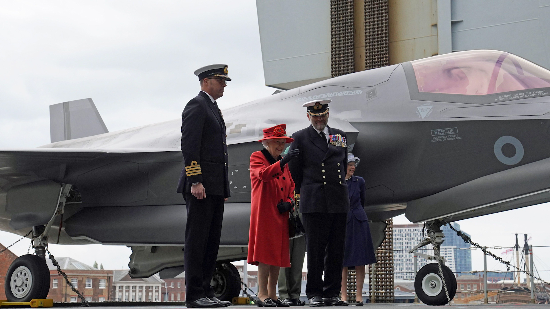 Captain Angus Essenhigh, Queen Elizabeth II and Commodore Steve Moorhouse on HMS Queen Elizabeth ahead of the ship's maiden deployment 220521 CREDIT PA Alamy.jpg