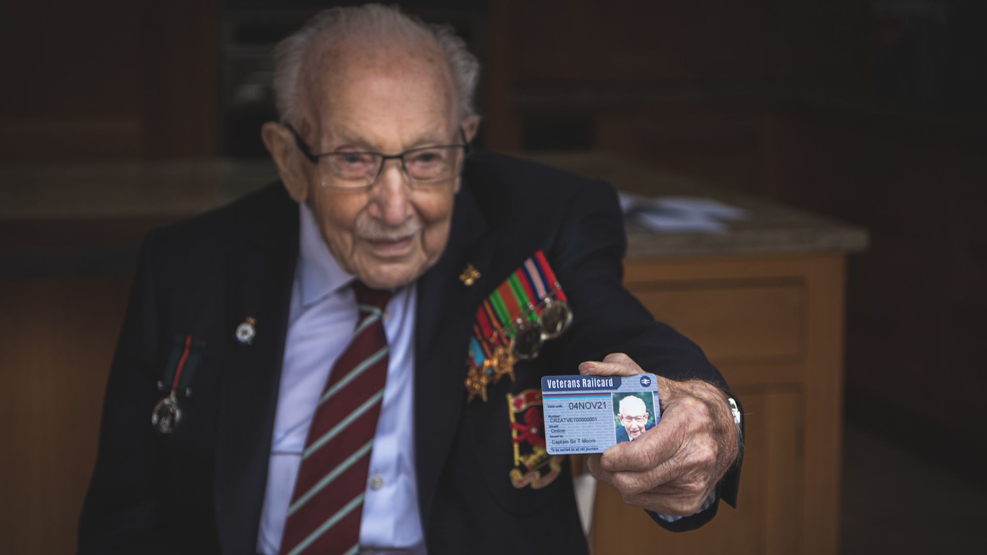 Captain Sir Tom Moore poses with first ever Veterans Railcard 131020 CREDIT Department of Transport.jpg 