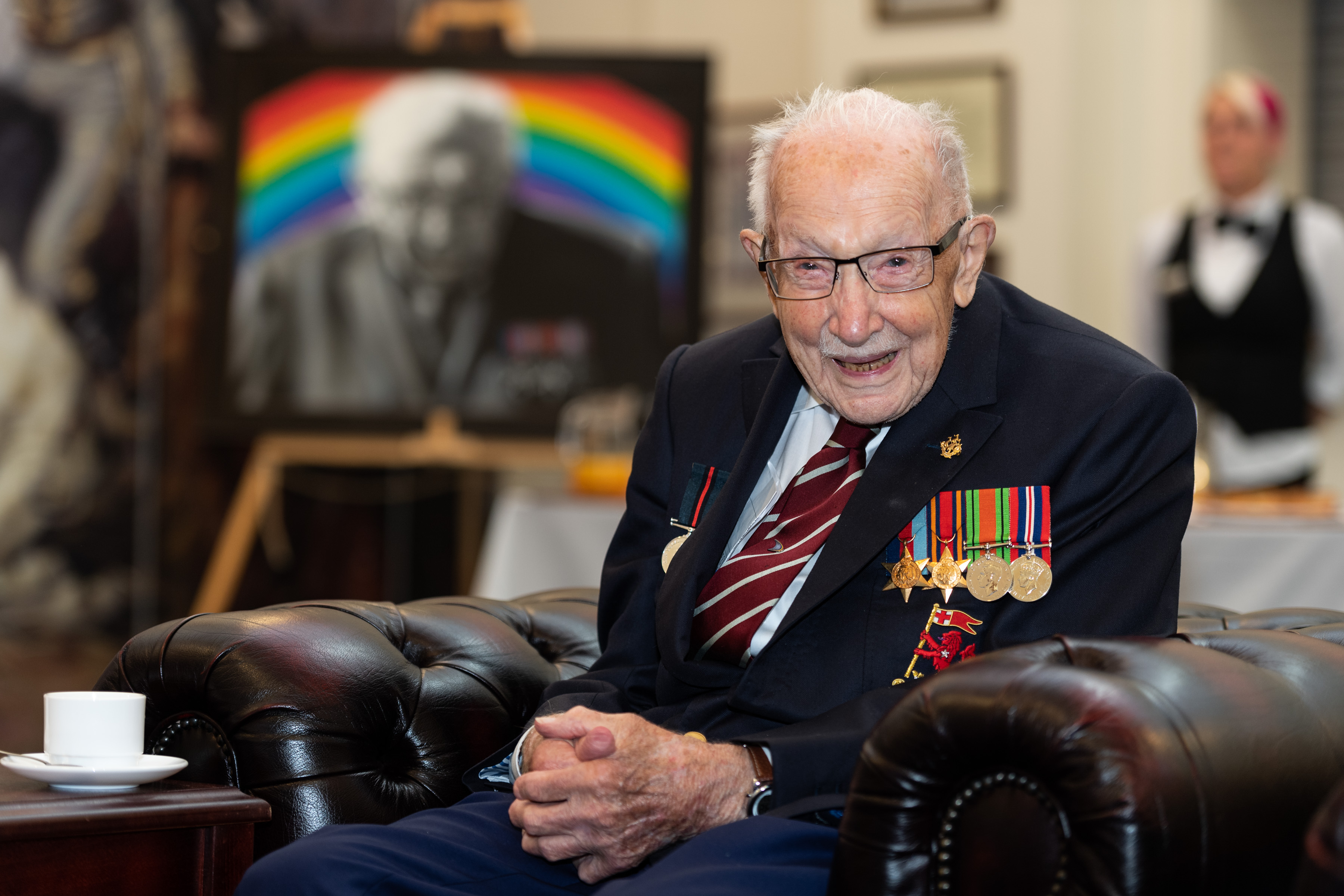 Captain Sir Tom Moore seated with his portrait behind him during a visit to the Army Foundation College in Harrogate in his new role as Honorary Colonel 030820 CREDIT MOD