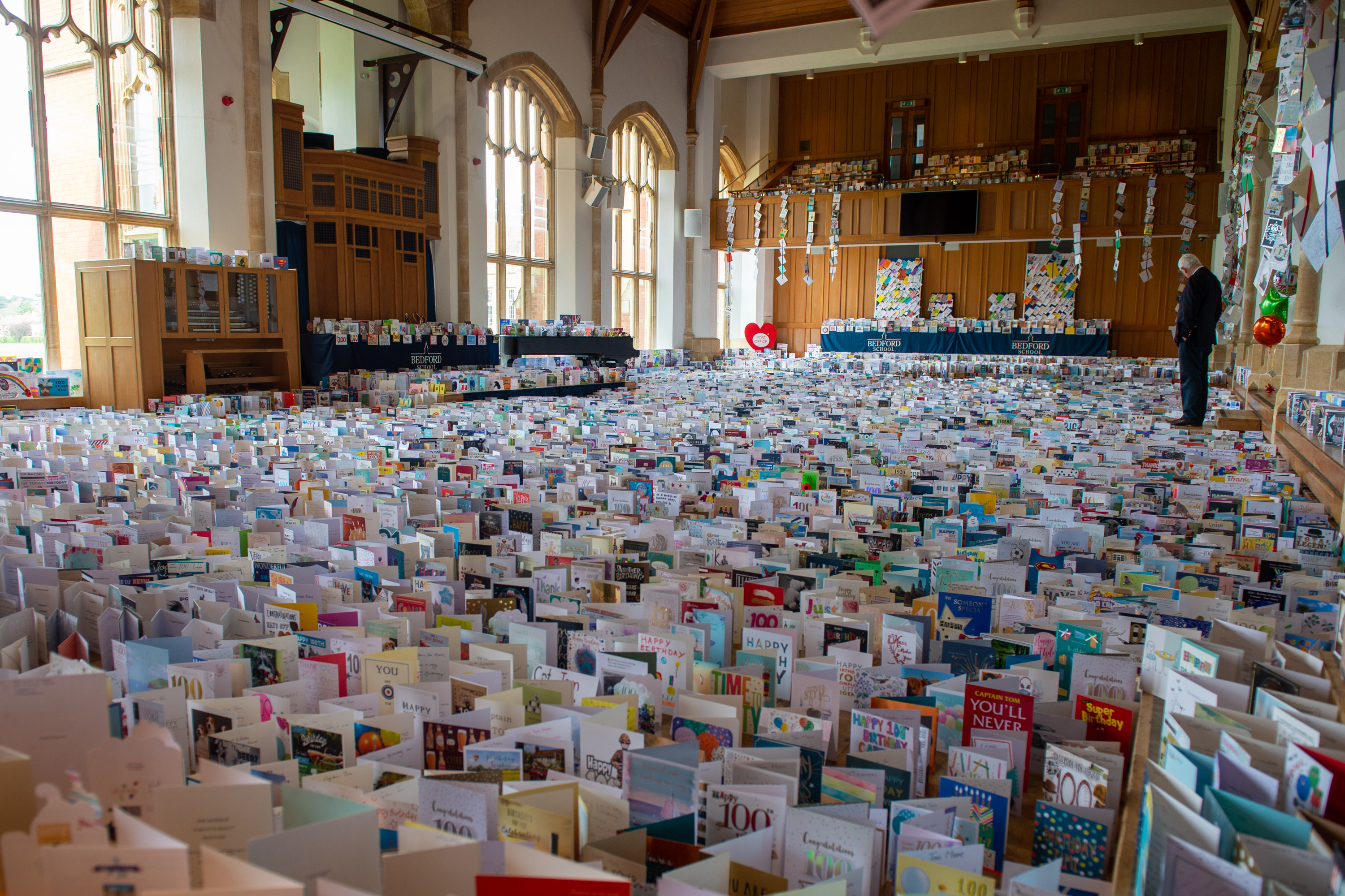 Cover image: Some of the 150,000 birthday cards sent to Captain Tom ahead of his birthday earlier this year (Picture: MOD).