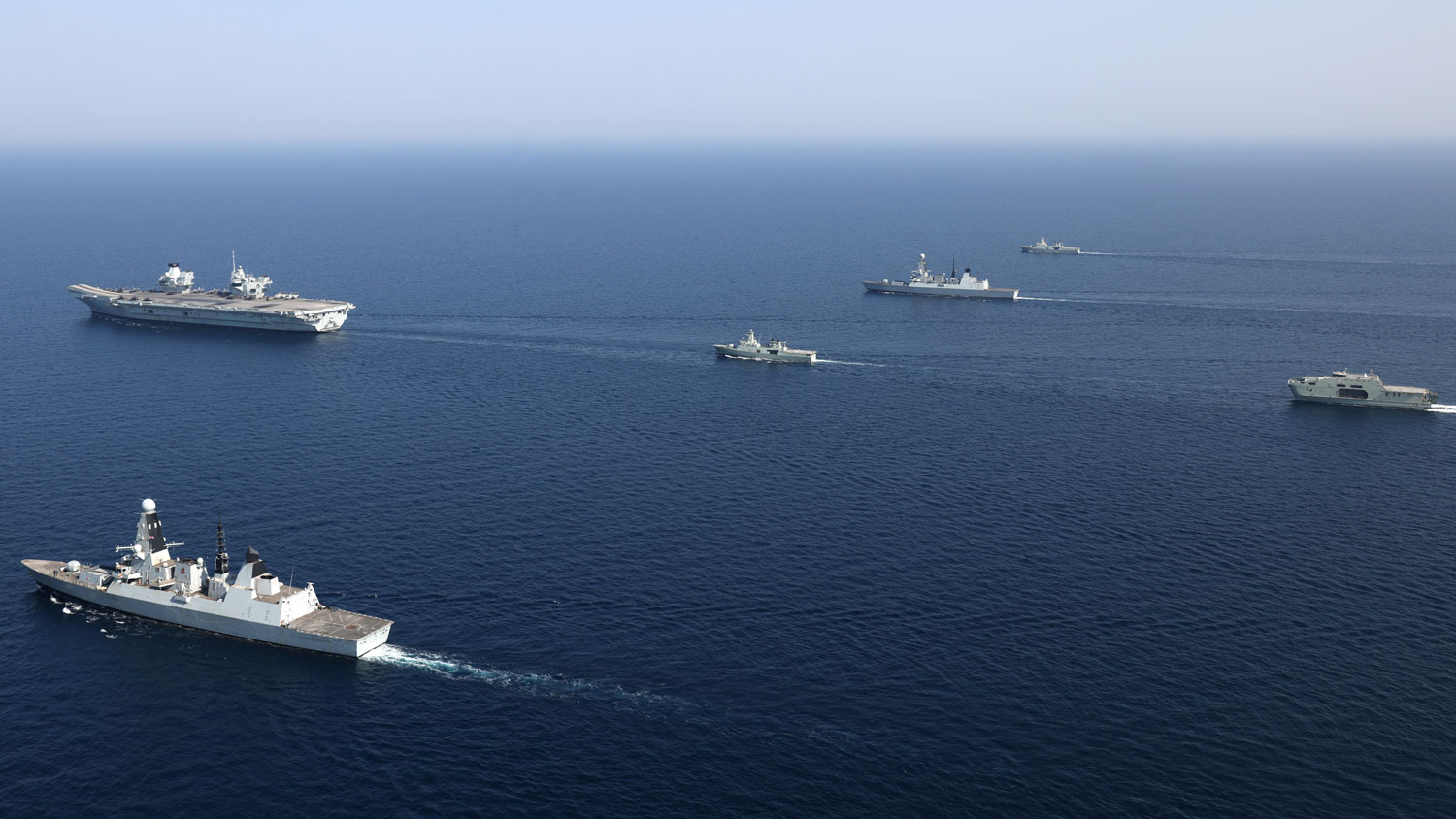 From left to right, front to back is HMS Queen Elizabeth, RNOV Shinas, HMS Defender, RNOV Sadh, HMS Diamond, RNOV Seeb and RNOV Al Mubshir (Picture: Crown Copyright).