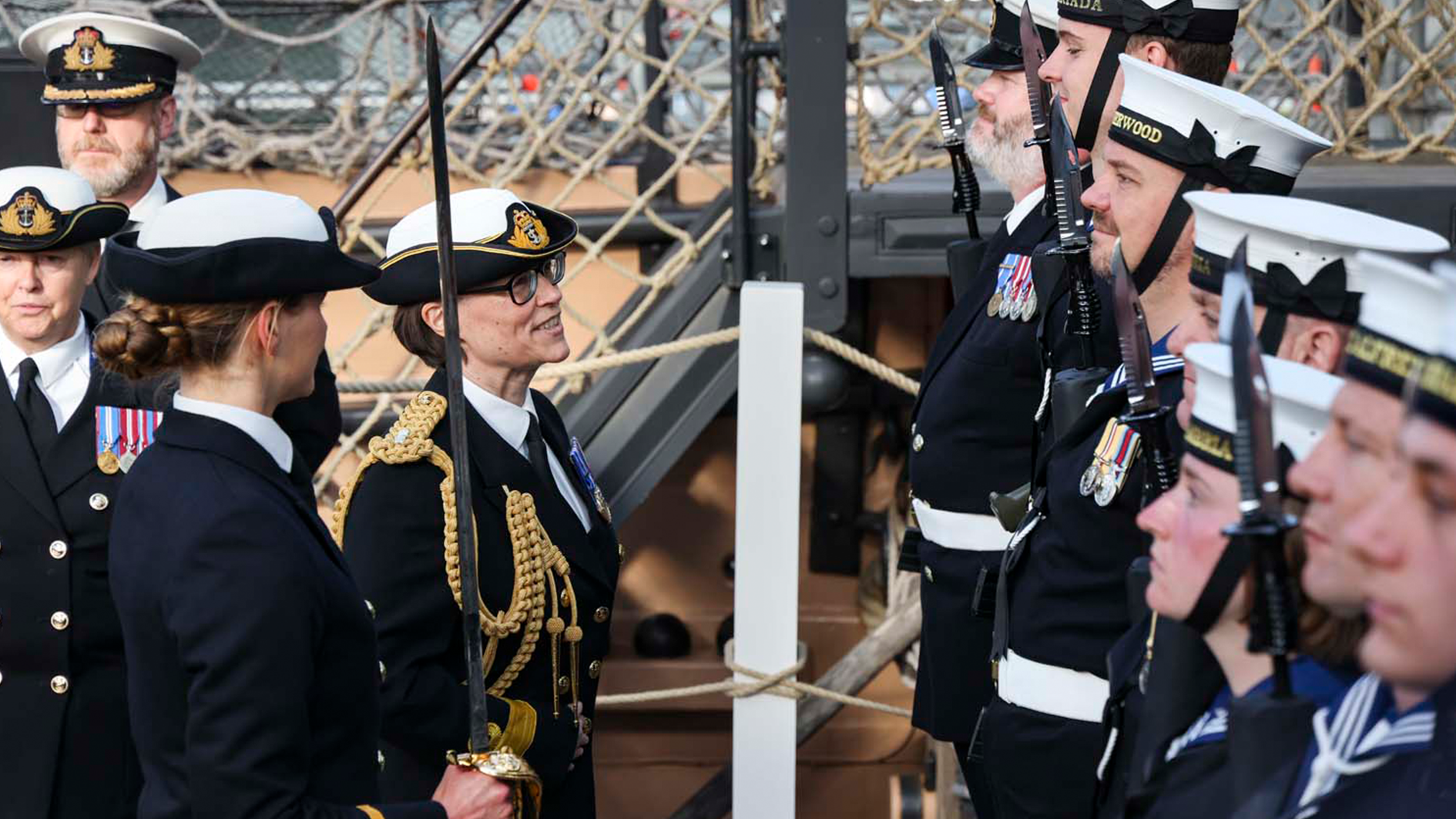 Cdr Jo Adey RN inspects the Guard of Honour, formed of sailors from Royal Navy Reserve units CREDIT ROYAL NAVY