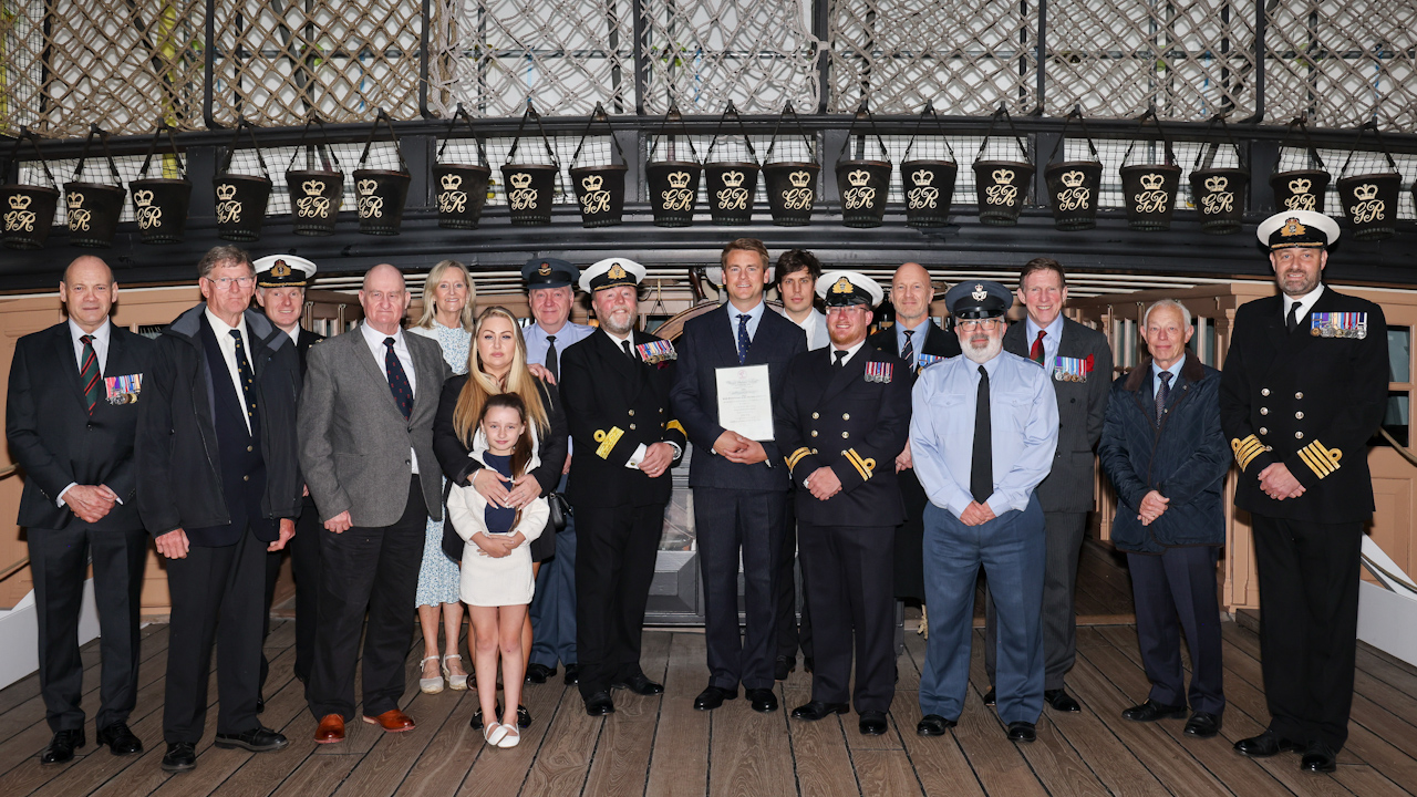 James Gray and Lt James Jeffcote with family and friends and representatives of the Royal Humane Society on HMS Victory (Picture: Royal Navy)