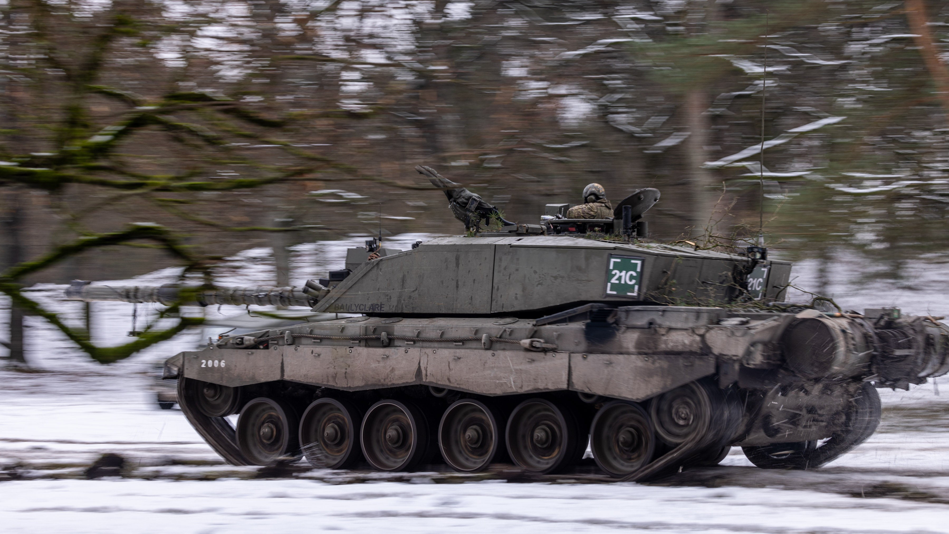 Challenger 2 Main Battle Tank from The Queens Royal Hussars moves across the snow during a combined arms manoeuvre on Sennerlager Training Area 23012023 CREDIT MOD Crown Copyright