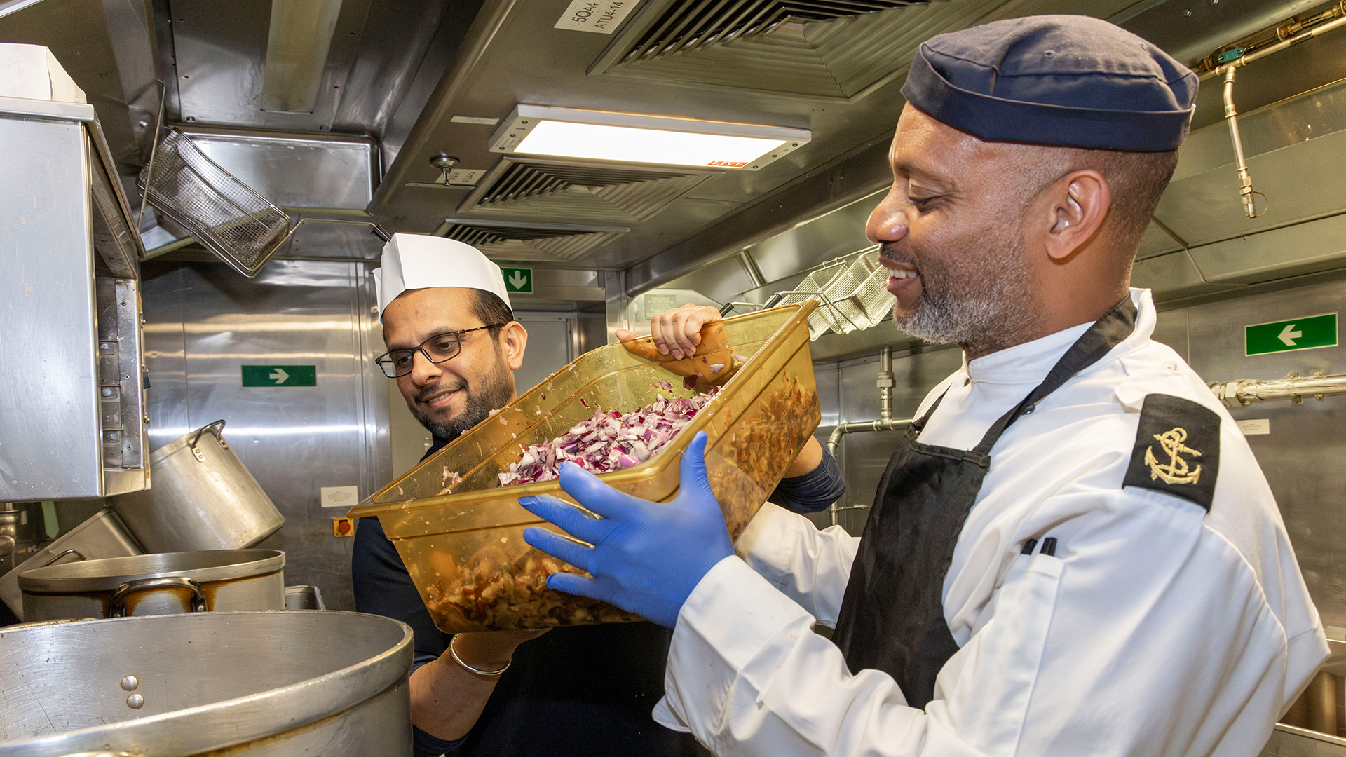 Chefs from the Punjab Restaurant cooking with Royal Navy chefs on board HMS Queen Elizabeth (Picture: MOD)