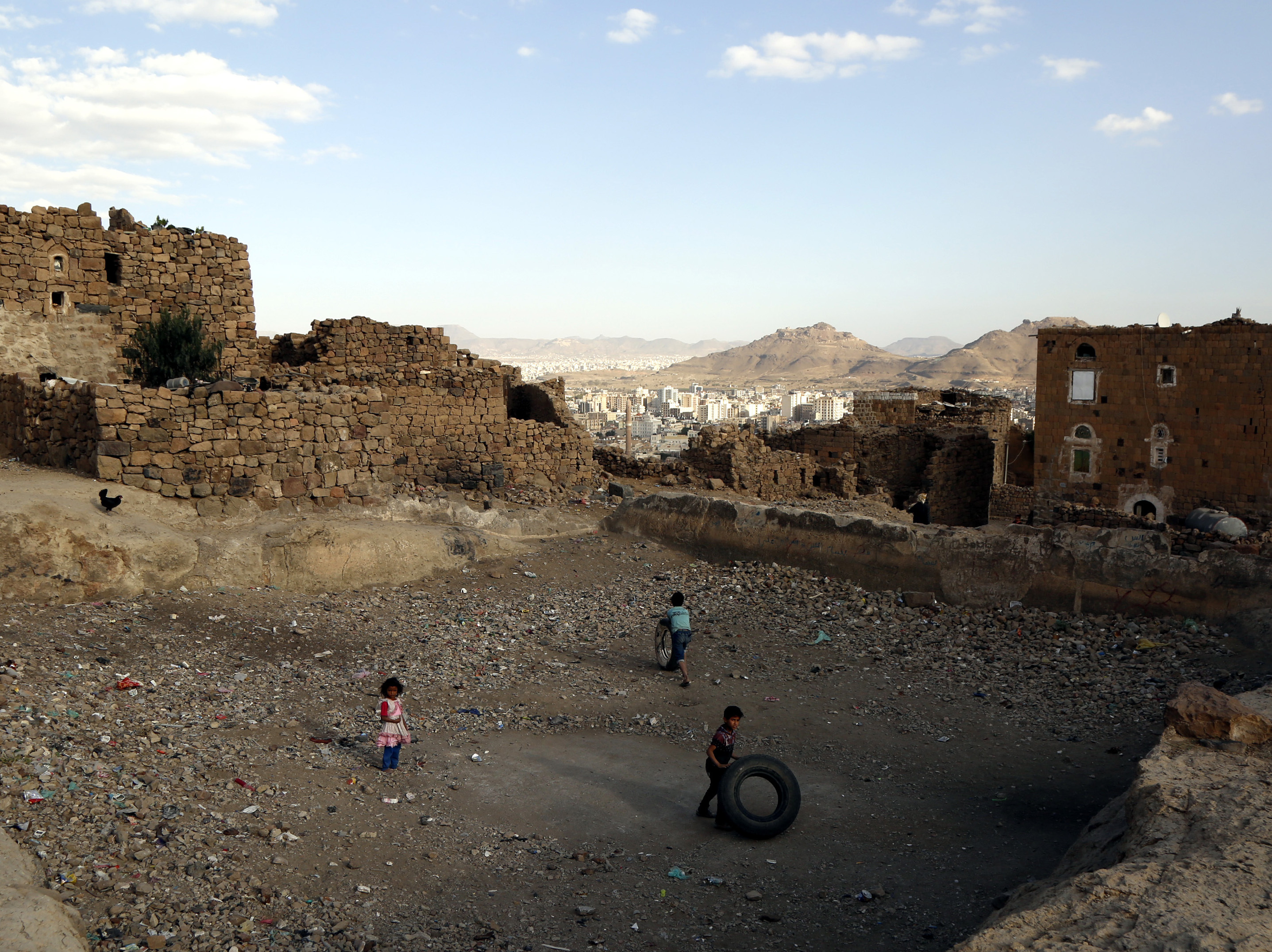 Chidren play near a house in Sanaa, Yemen