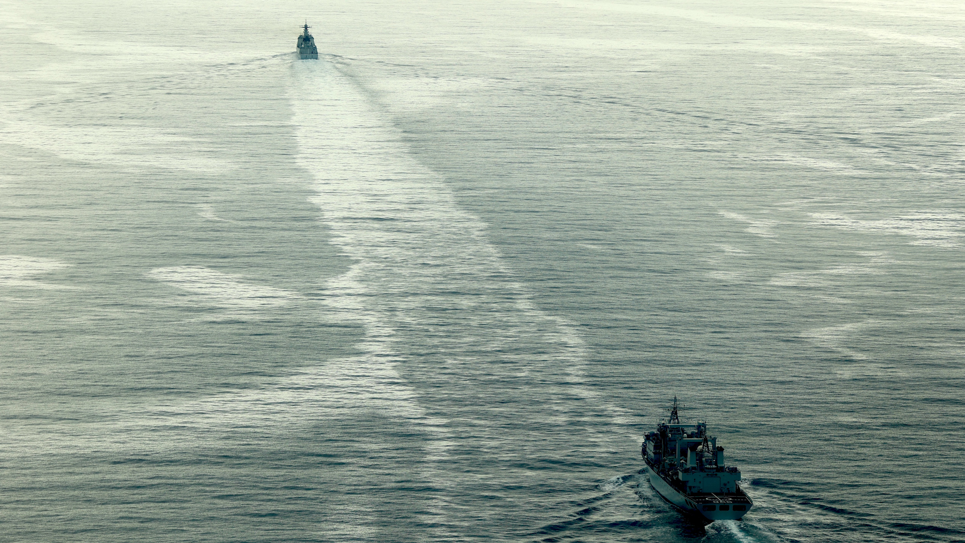 Chinese destroyer Jiaozuo and support vessel Honghu move through the Channel -monitored by HMS Richmond's Merlin 100824 CREDIT Royal Navy