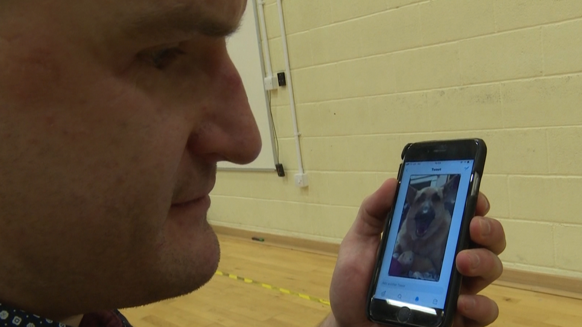 Blind veteran Rob Long listens to Twitter visual aid