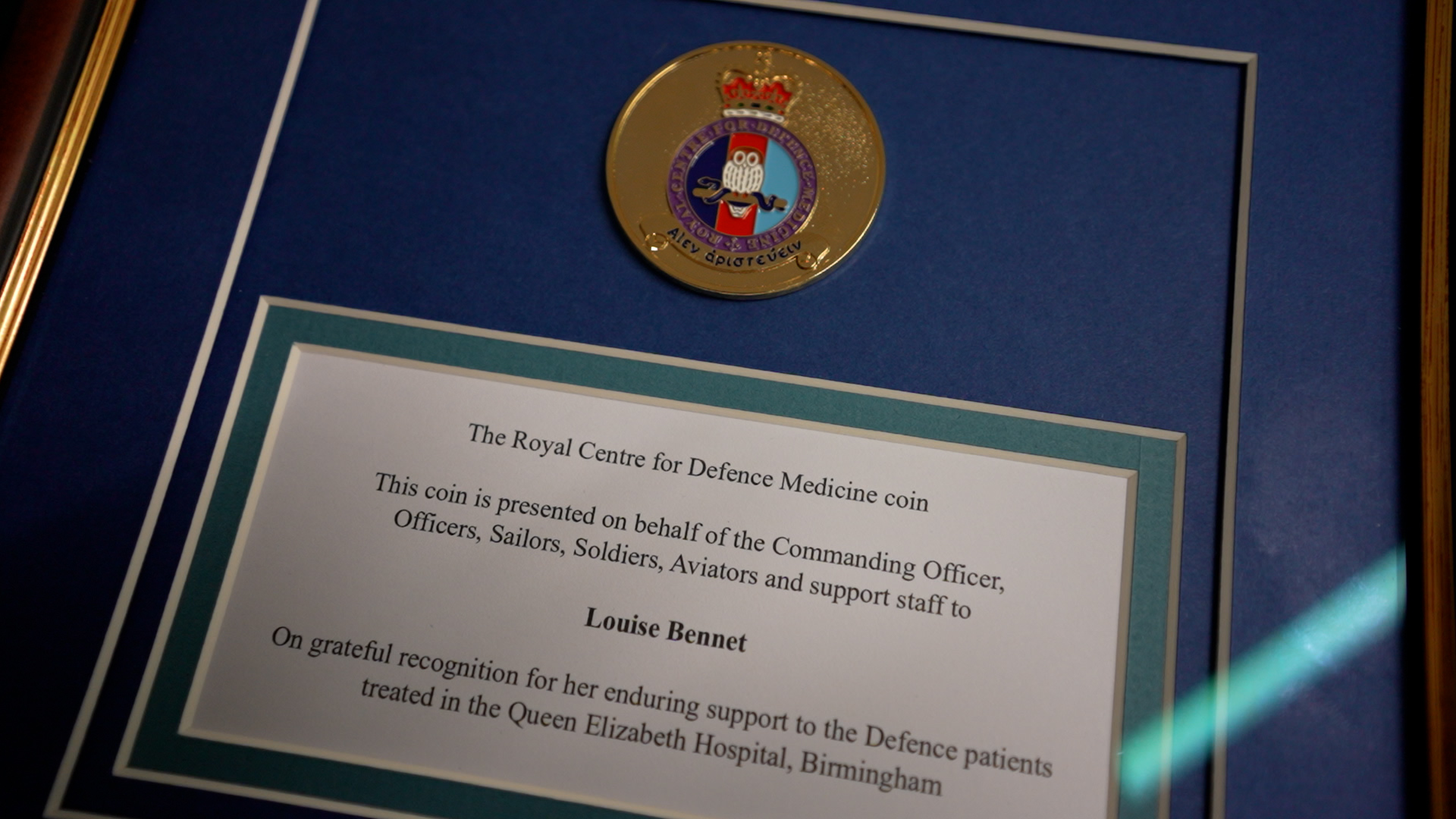 Coin Plaque presented to Louise Bennet for making buns for troops for over 20 years