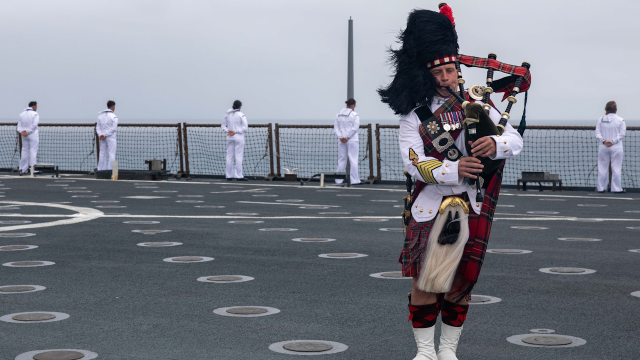 Colour Sergeant (Pipe Major) James Muir playing the pipes aboard USS Pearl Harbour (Picture: British Army).