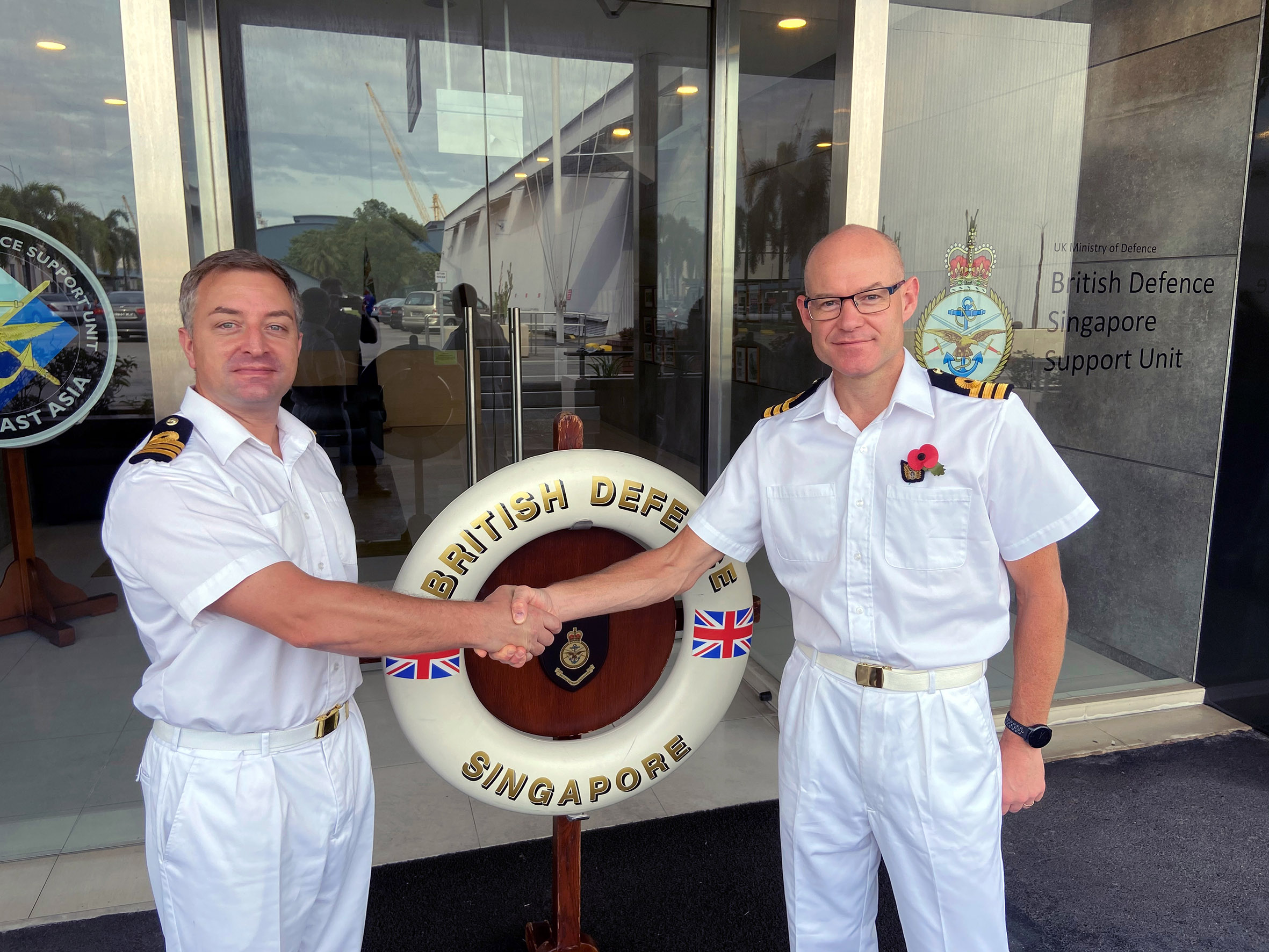 Cover image: Commander Paul Bastiaens (left) hands over command in Singapore to Commander Tim Hutchins (Picture: Royal Navy).