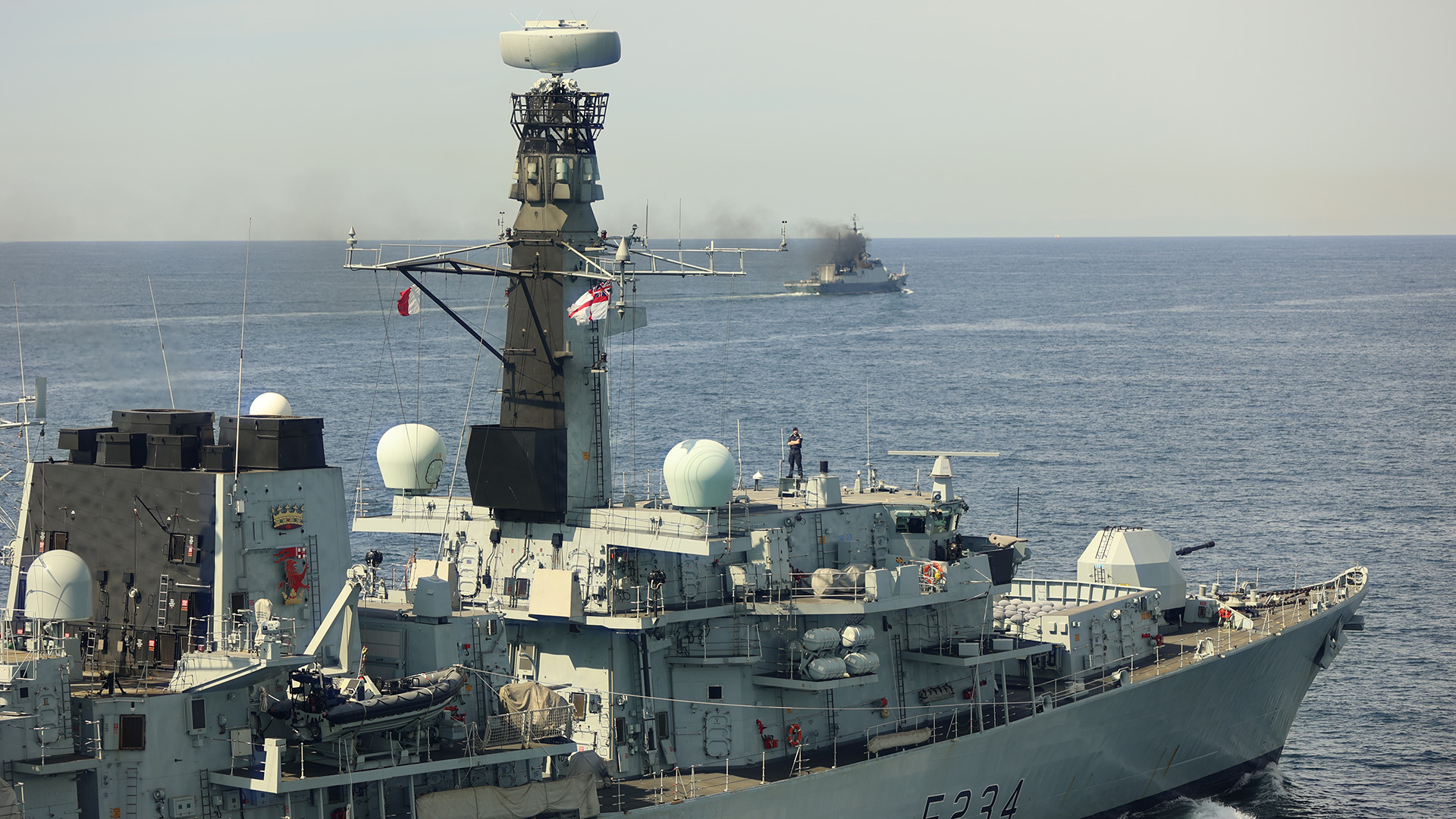 Commanding Officer of HMS Iron Duke Commander David Armstrong atop the ship bridge roof during monitoring of RFN Boikiy 09072025 Credit Royal Navy