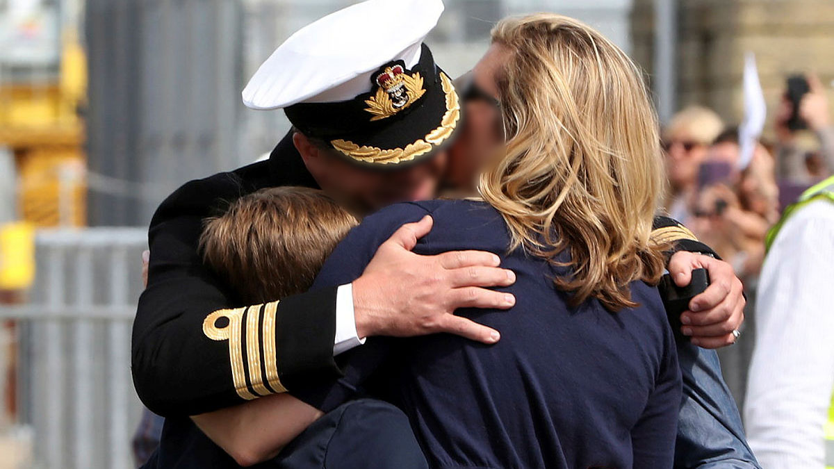 The Commanding Officer of a Royal Navy ship is welcomed home by his family (Picture: Crown Copyright).