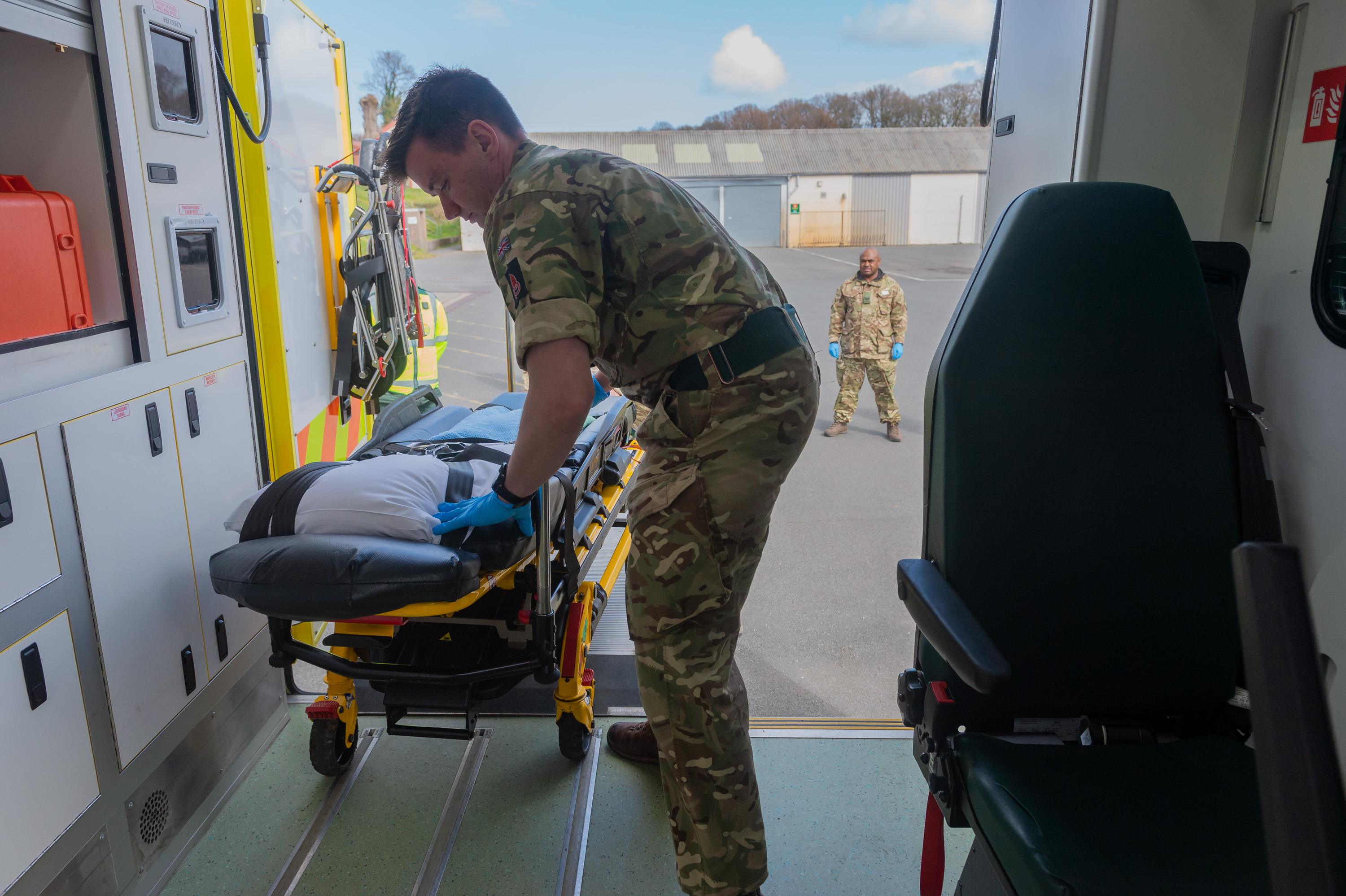 Coronavirus Welsh Ambulance Service - a member of Seven Brigade loads a stretcher onto an ambulance ready for use 060420 CREDIT MOD.jpg