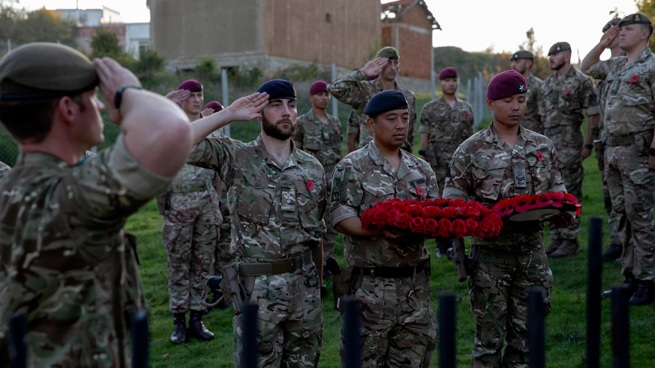 Corporal Bishwaraj Rai (far right) lays a wreath for his uncle, Sergeant Balaram Rai, was killed in the Kosovo War in 1999