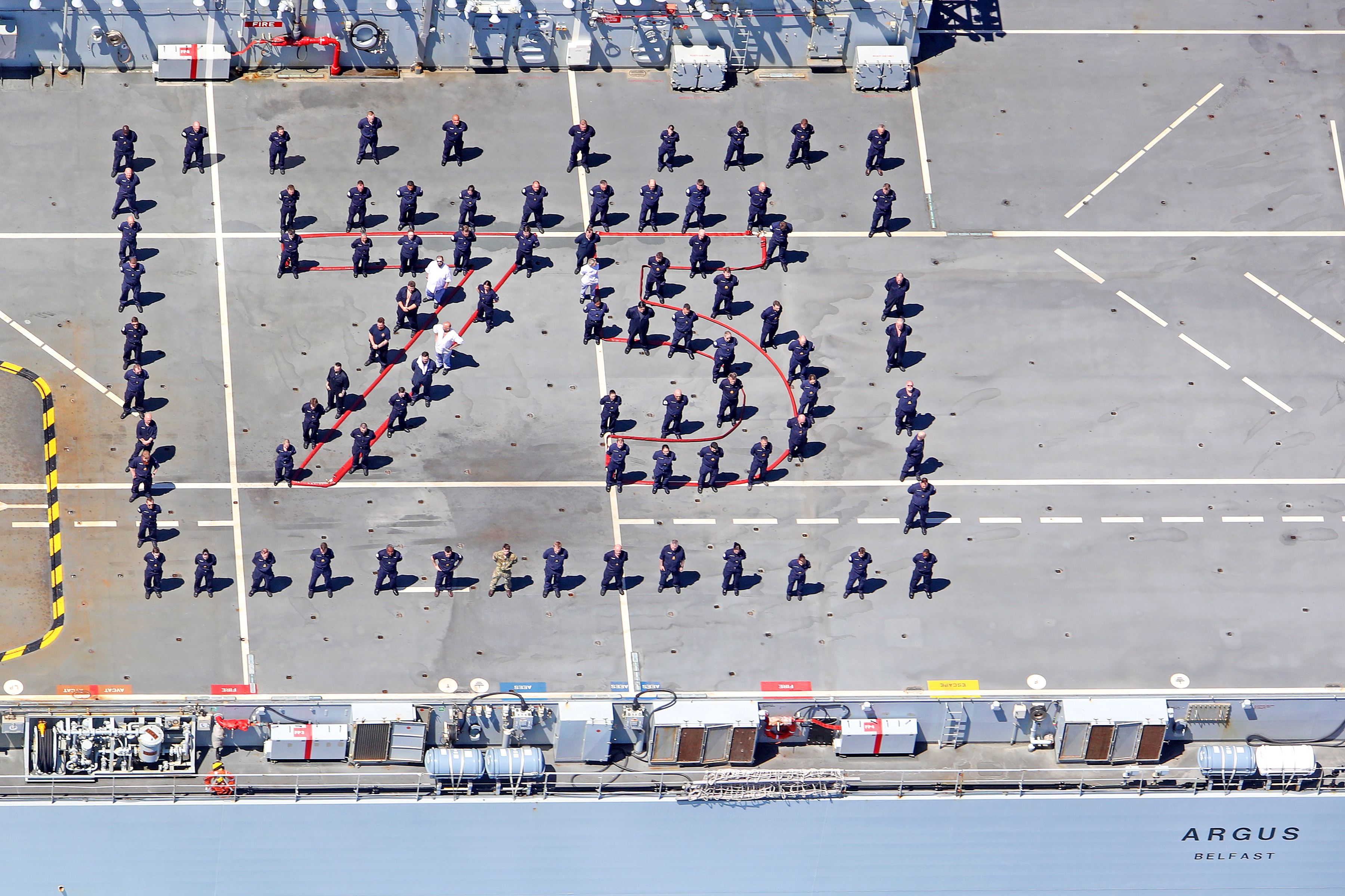 Cover image: Crew on board RFA Argus spell out '75' for VE Day (Picture: Royal Navy).