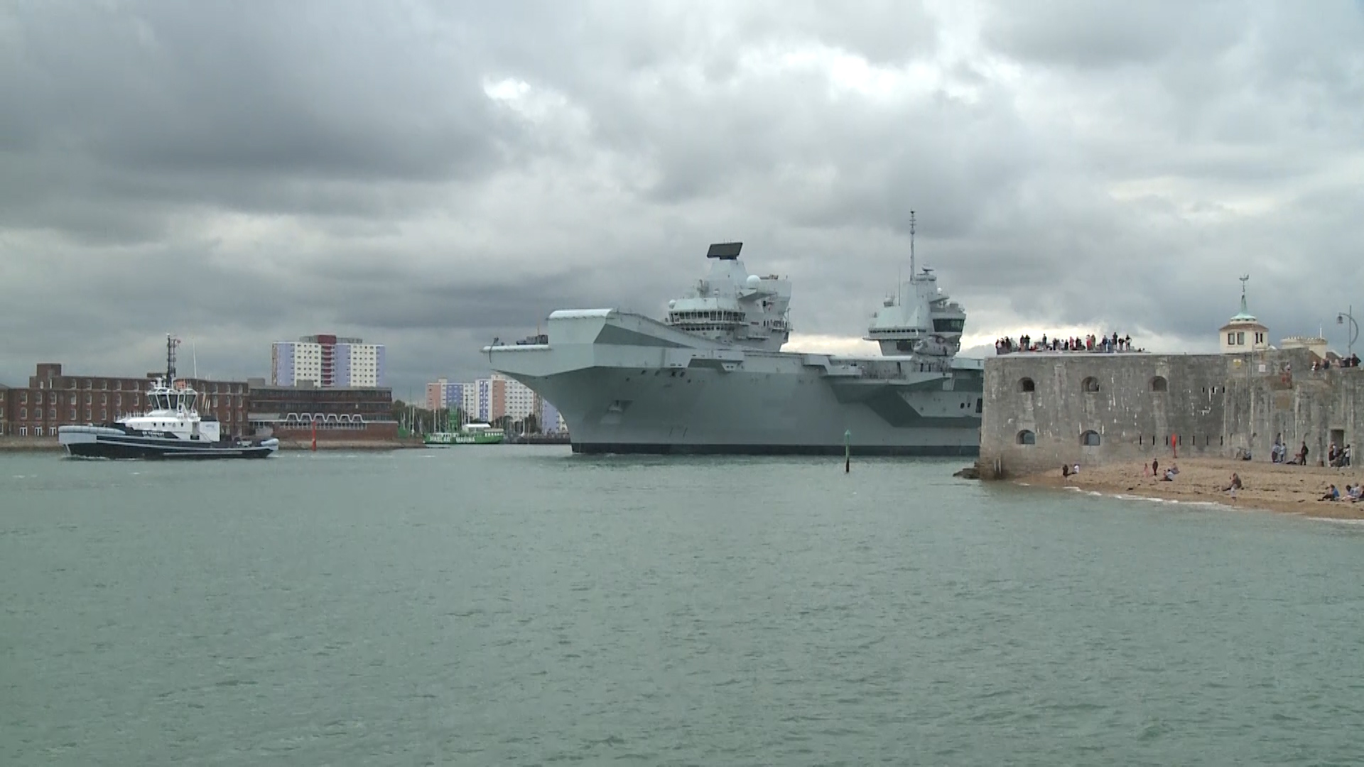 Crowds gather to watch HMS Queen Elizabeth depart Portsmouth for training exercises after her departure date was suspended due to COVID-19