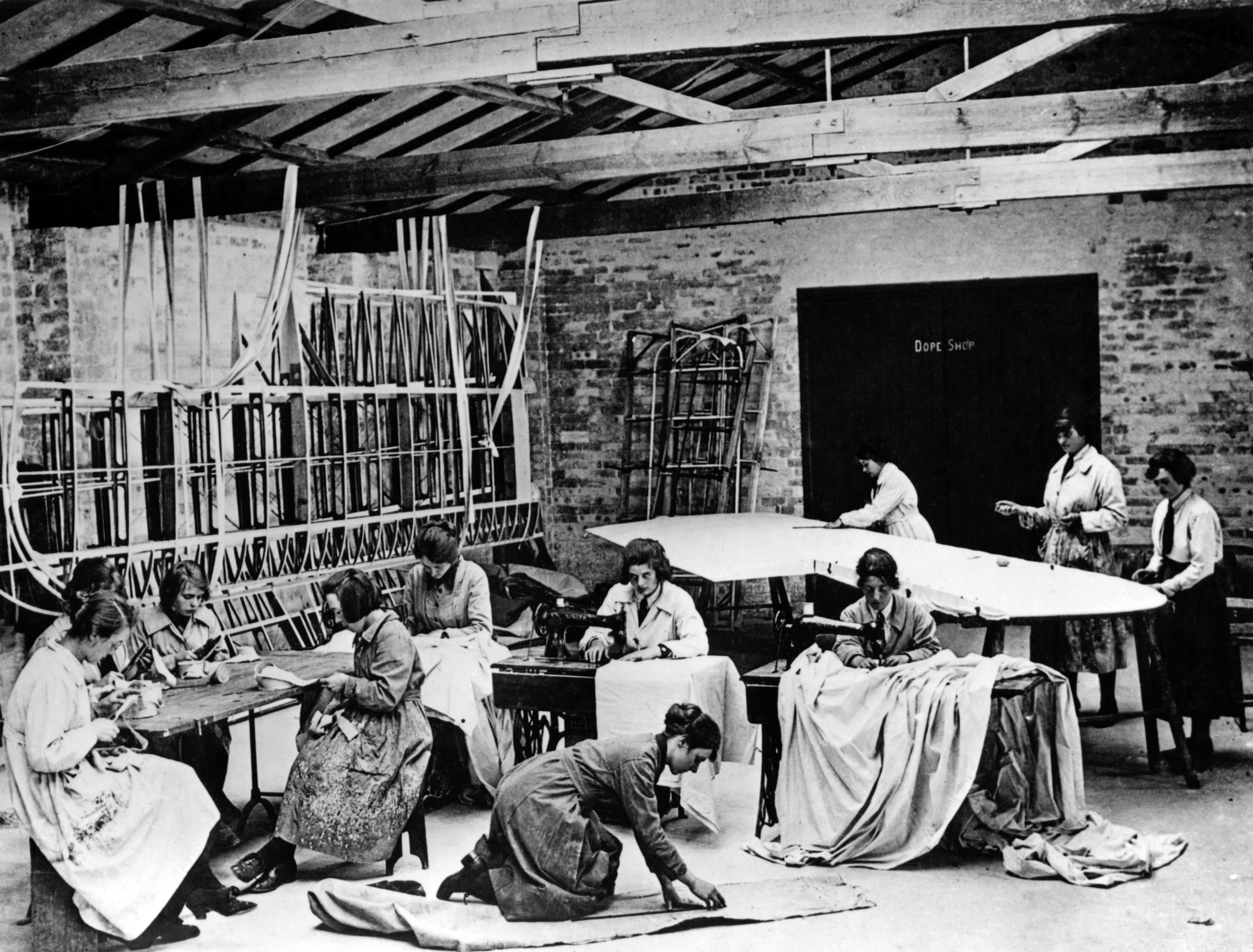 WRAFs sewing fabric and attaching it to pre-built aircraft frames and wings, July 1918