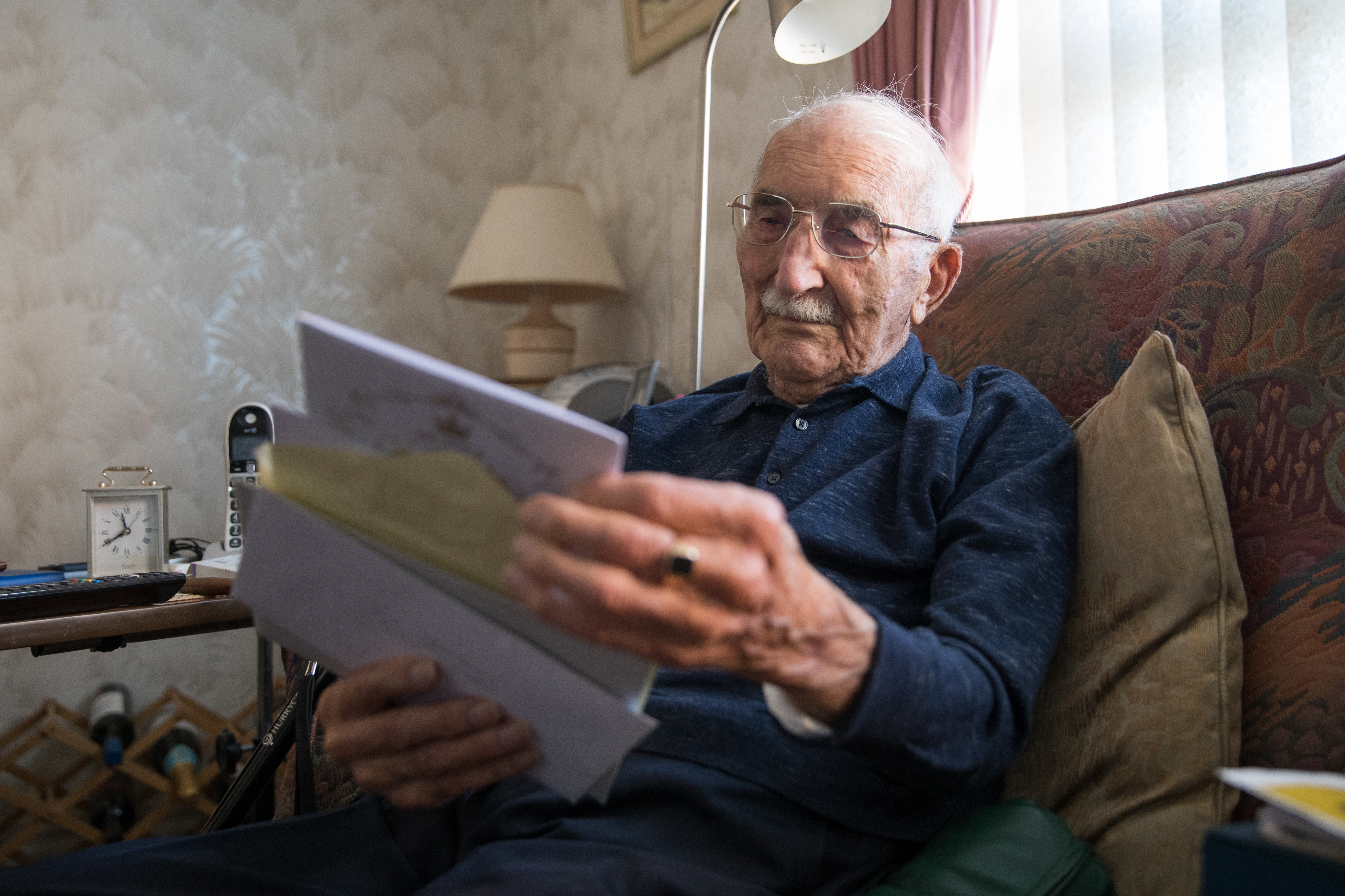 John Jenkins looks through birthday cards on his 100th birthday (Picture: PA).