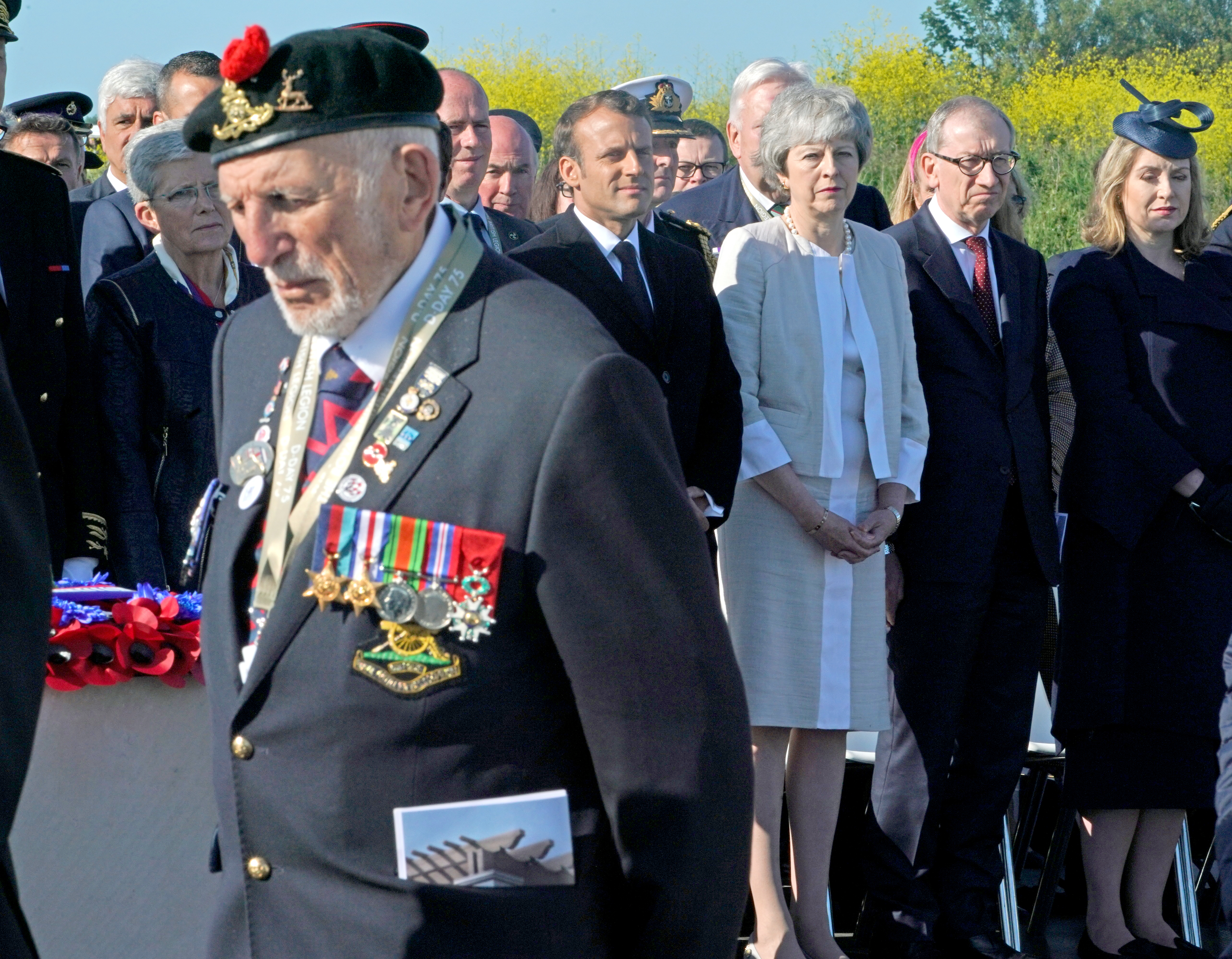 D-Day veteran passes Emmanuel Macron and Theresa May at the Inauguration of the British Normandy Memorial 060619 CREDIT PA
