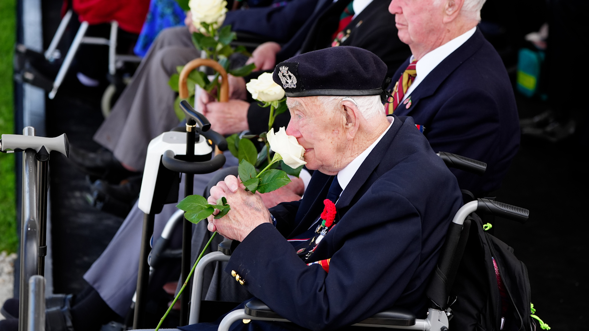 D-Day veterans hold roses presented by school children D Day 80 British Normandy Memorial in Ver-sur-Mer 060624 CREDIT PA.jpg