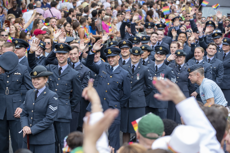 RAF personnel are seen here waving to the crowds, as they take part in the Pride in London Parade.