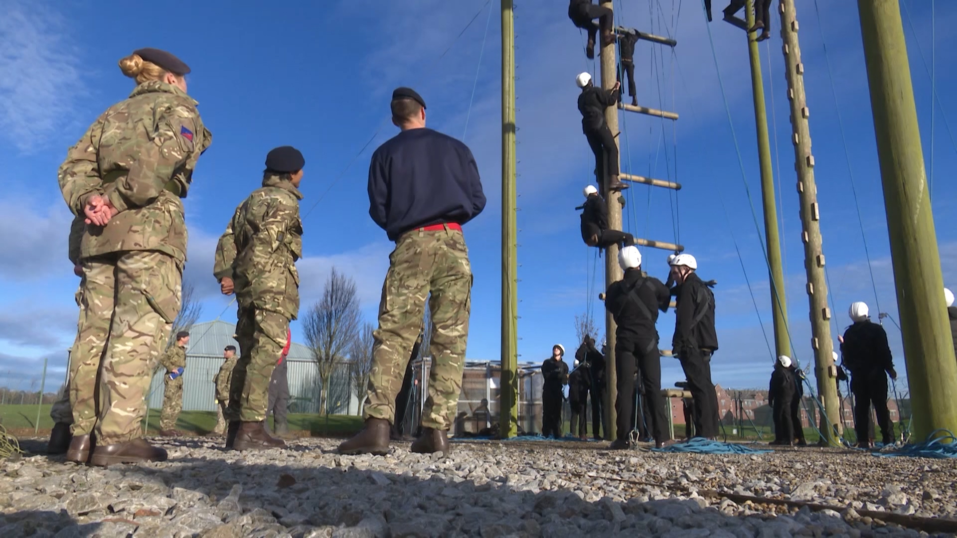 Dame Kelly watches the young soldiers on a high ropes course, designed to test their leadership and teamwork skills. 