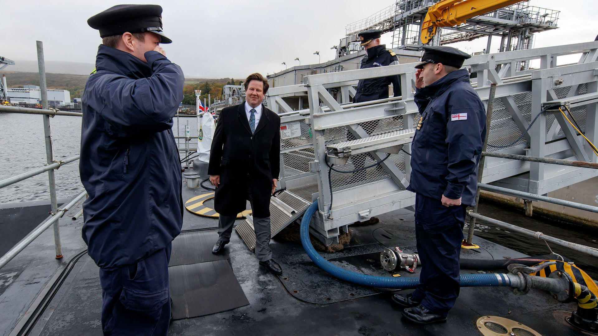Submariners wearing black caps welcomed defence minister Alec Shelbrooke on board HMS Ambush